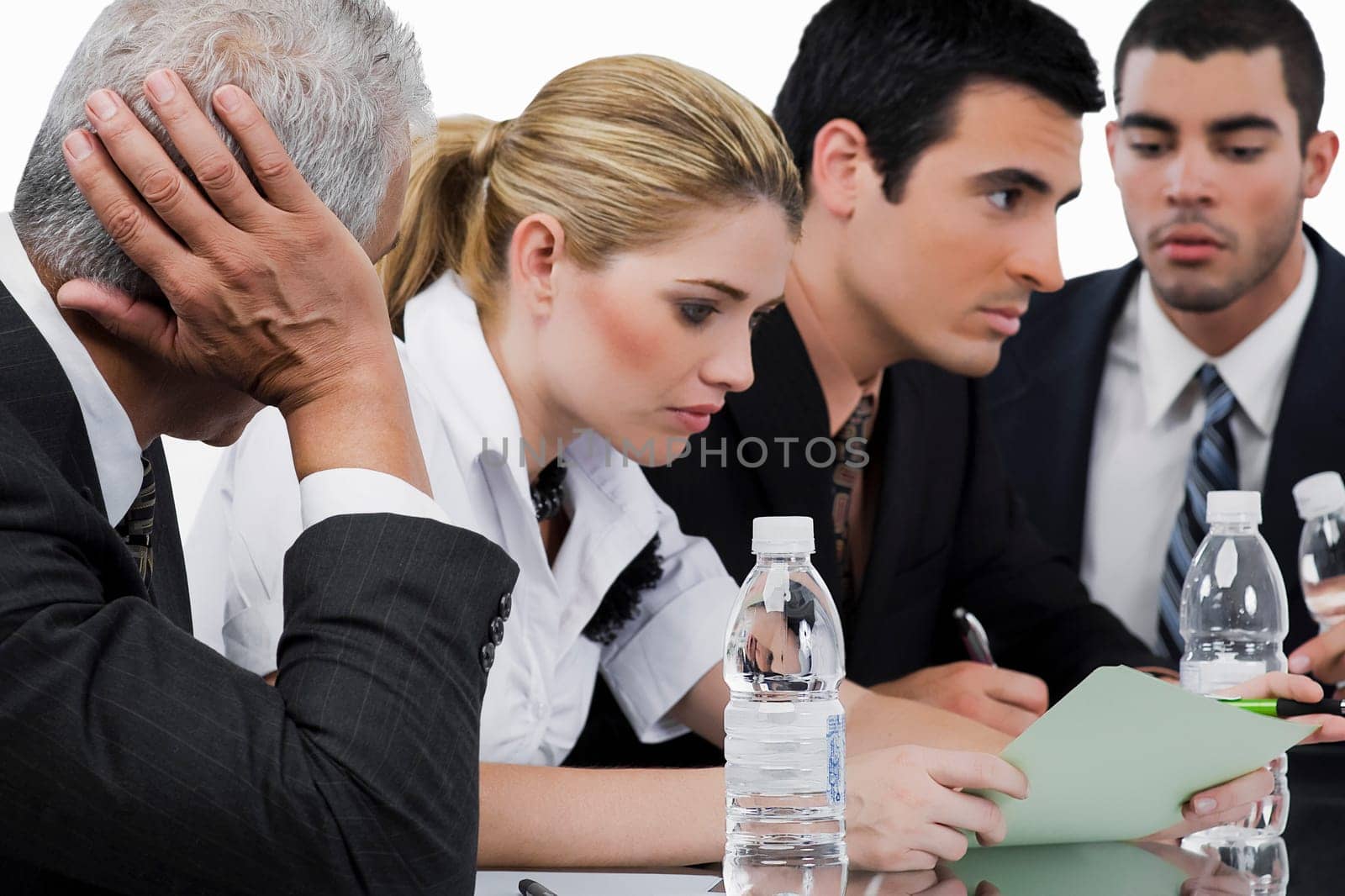 Three businessmen and a businesswoman at a meeting in a conference room