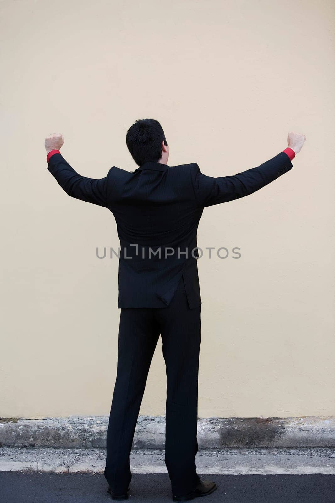 Businessman standing with his arm outstretched
