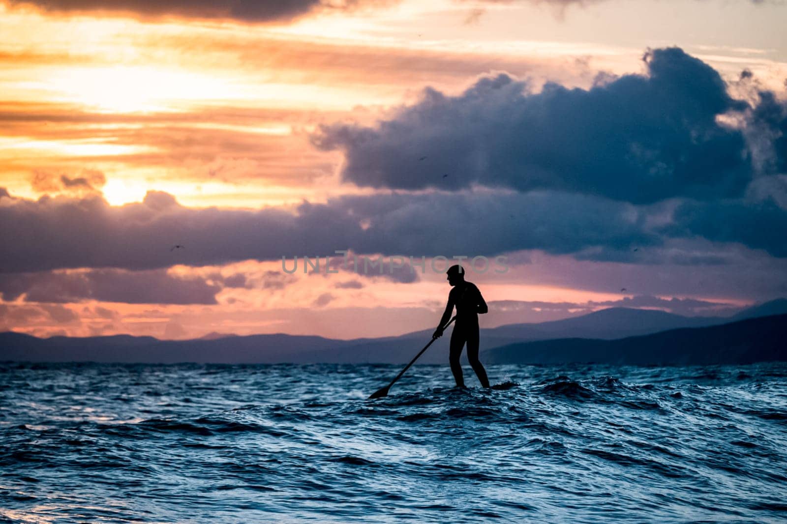 Sapboard with paddle on the water. One sport of sapboarding.