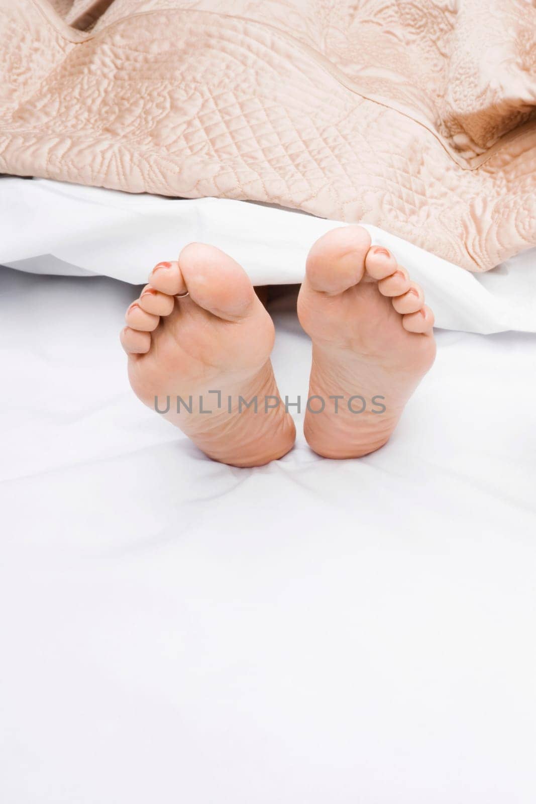 Close-up of a woman's feet on the bed