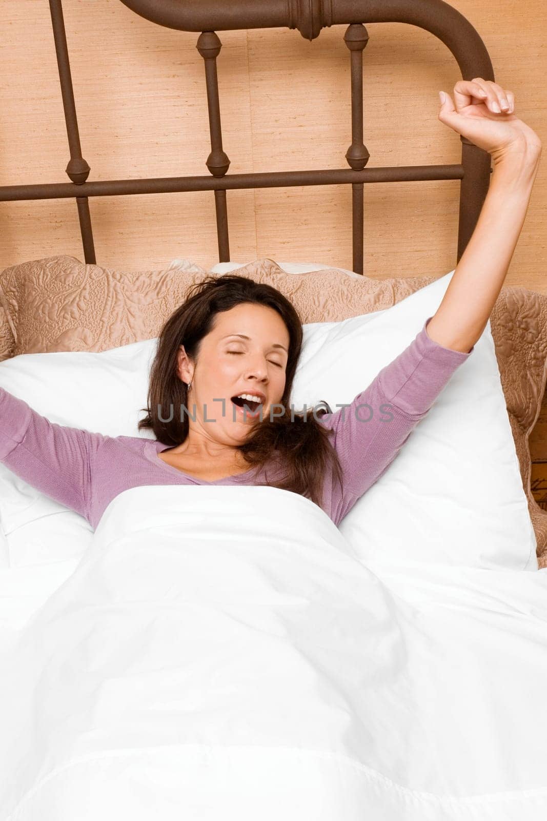 High angle view of a mid adult woman waking up