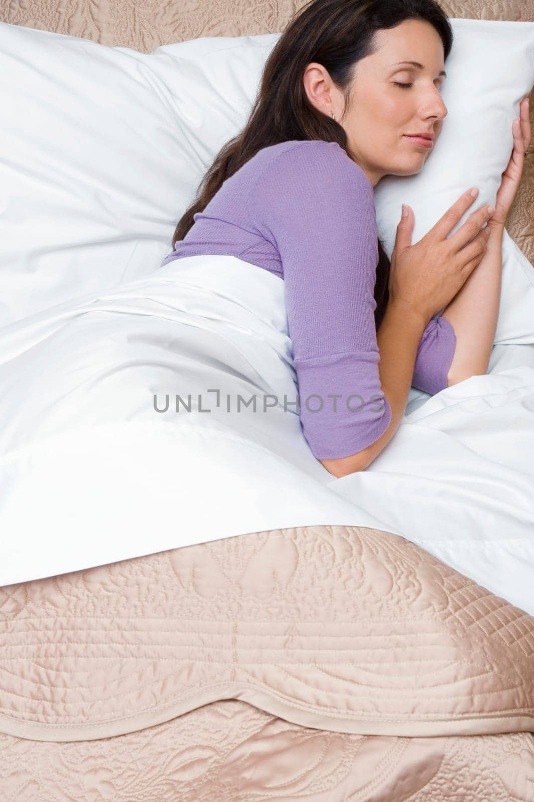 Side profile of a mid adult woman sleeping on the bed
