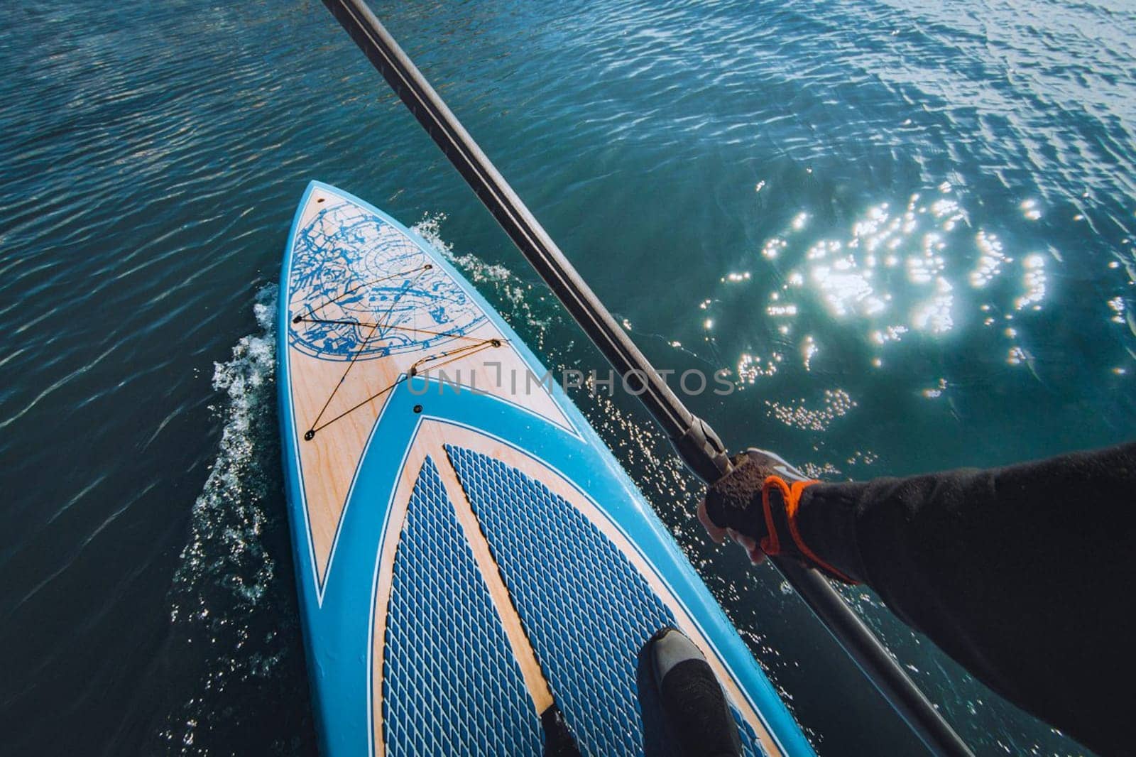 Sapboard with paddle on the water. One sport of sapboarding.