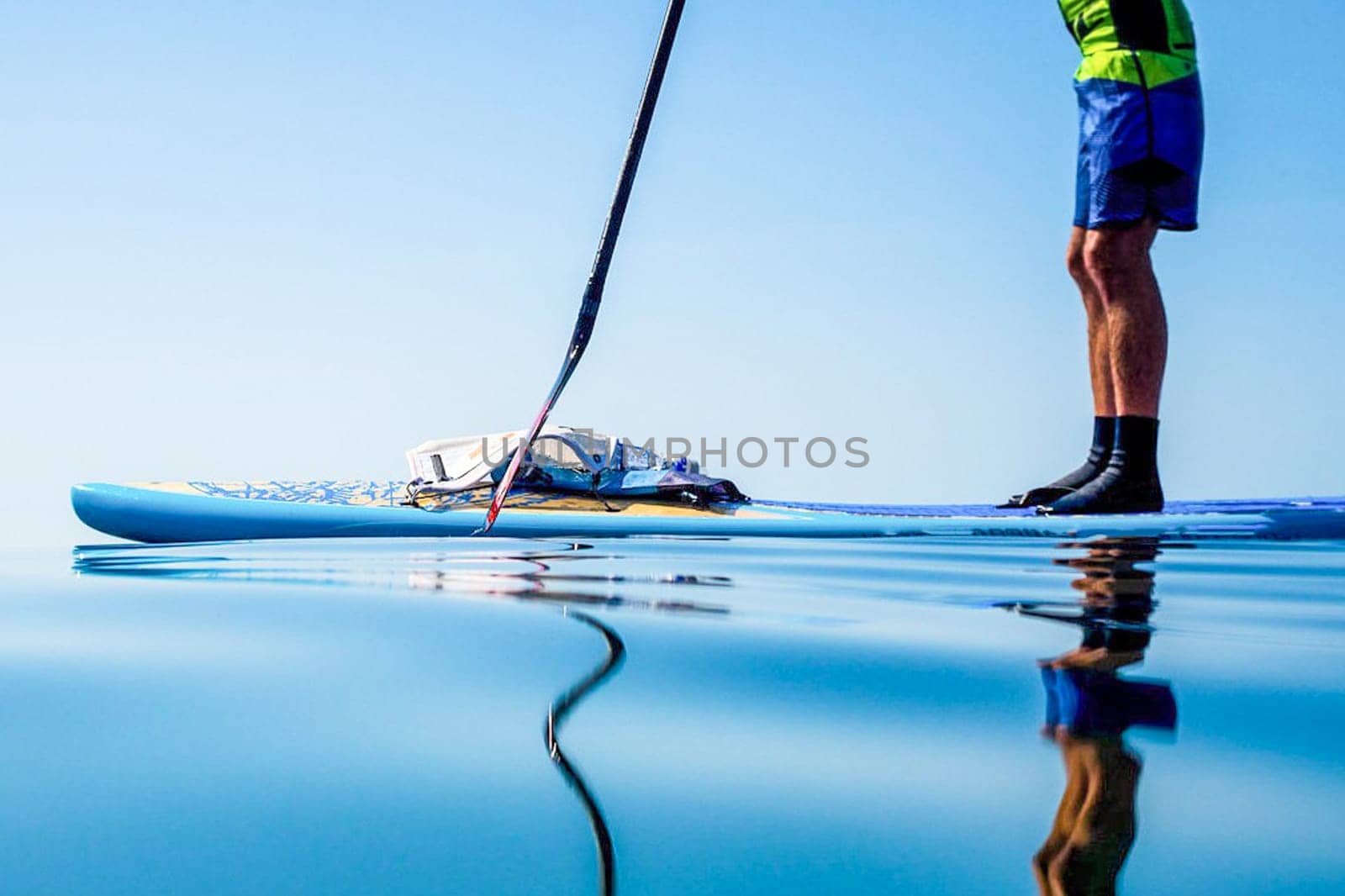 Sapboard with paddle on the water. One sport of sapboarding.