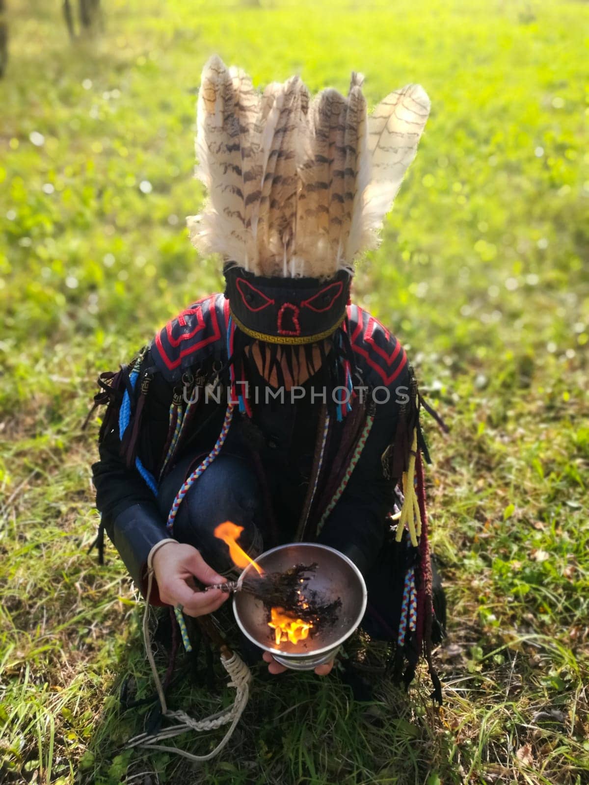 The shaman performs a ritual with the burning of grass.