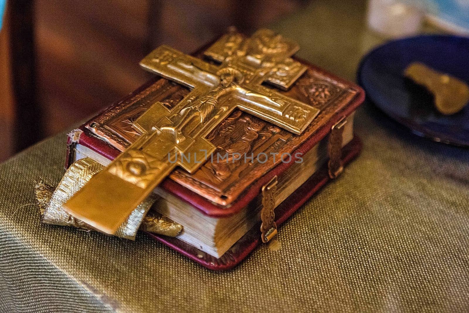 an old bible with a lock on the binding and a cross is on the book.