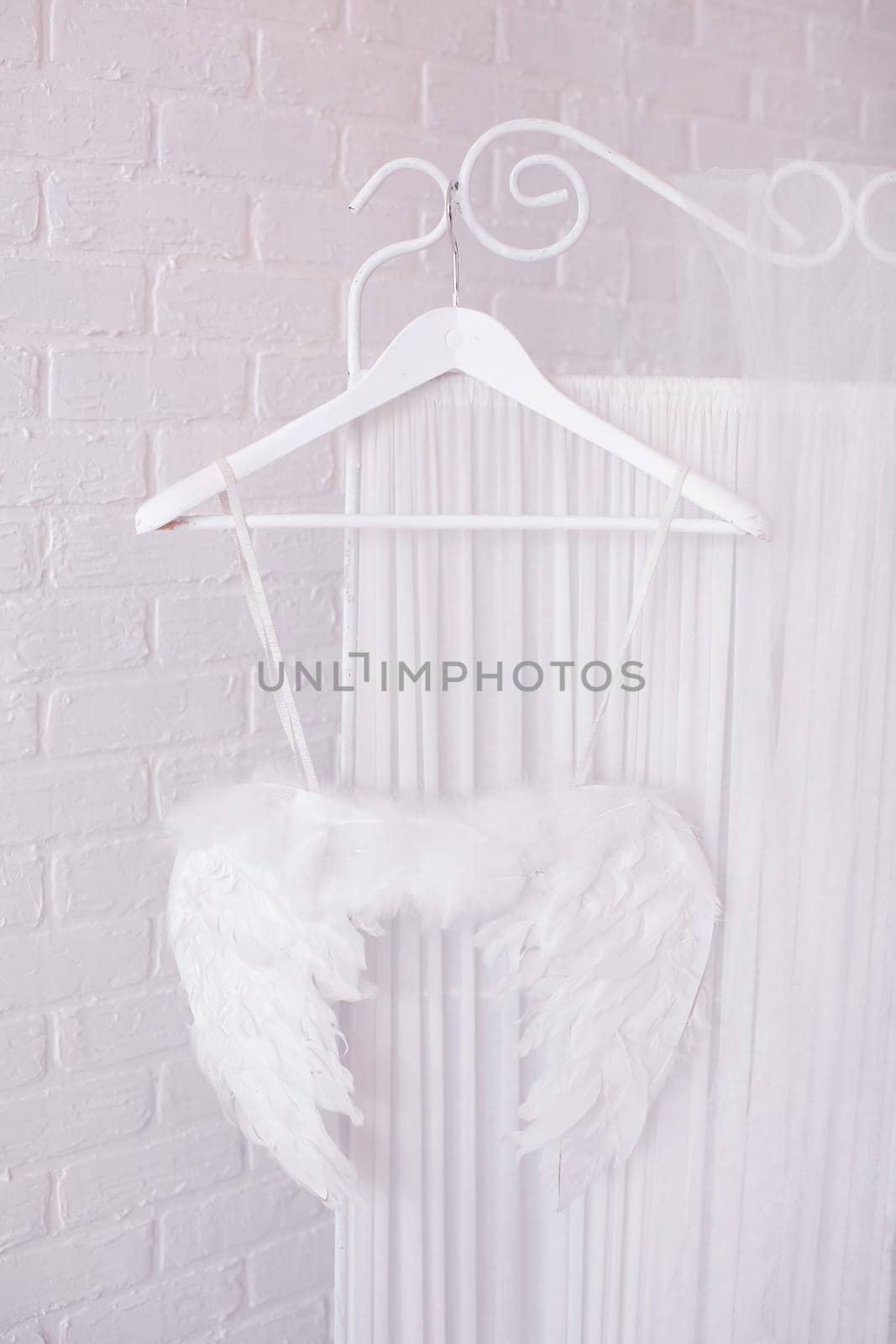 The wings of an angel on a hanger. The white feathers.