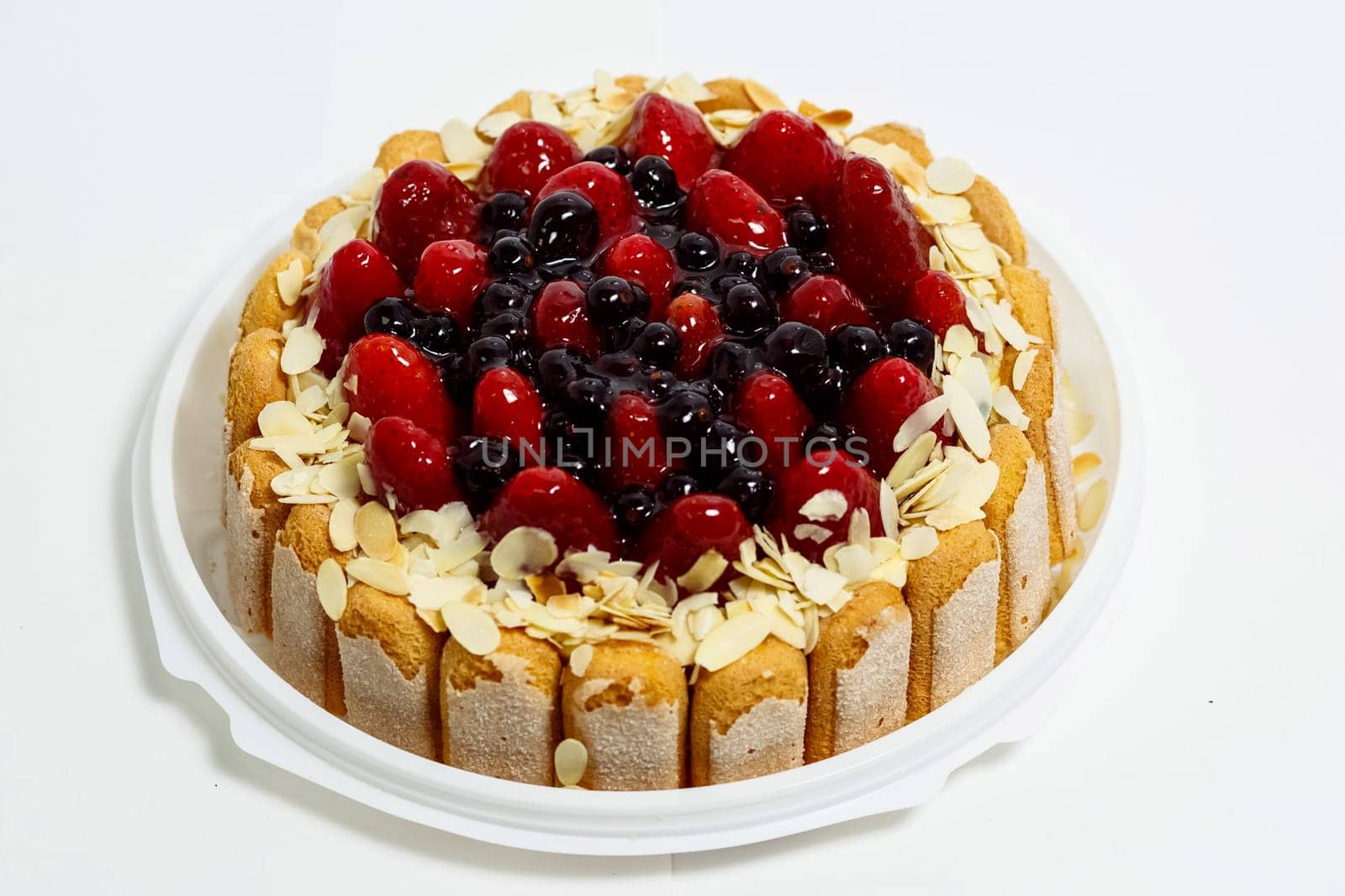Cake with strawberries and currants. Cake on a white background.