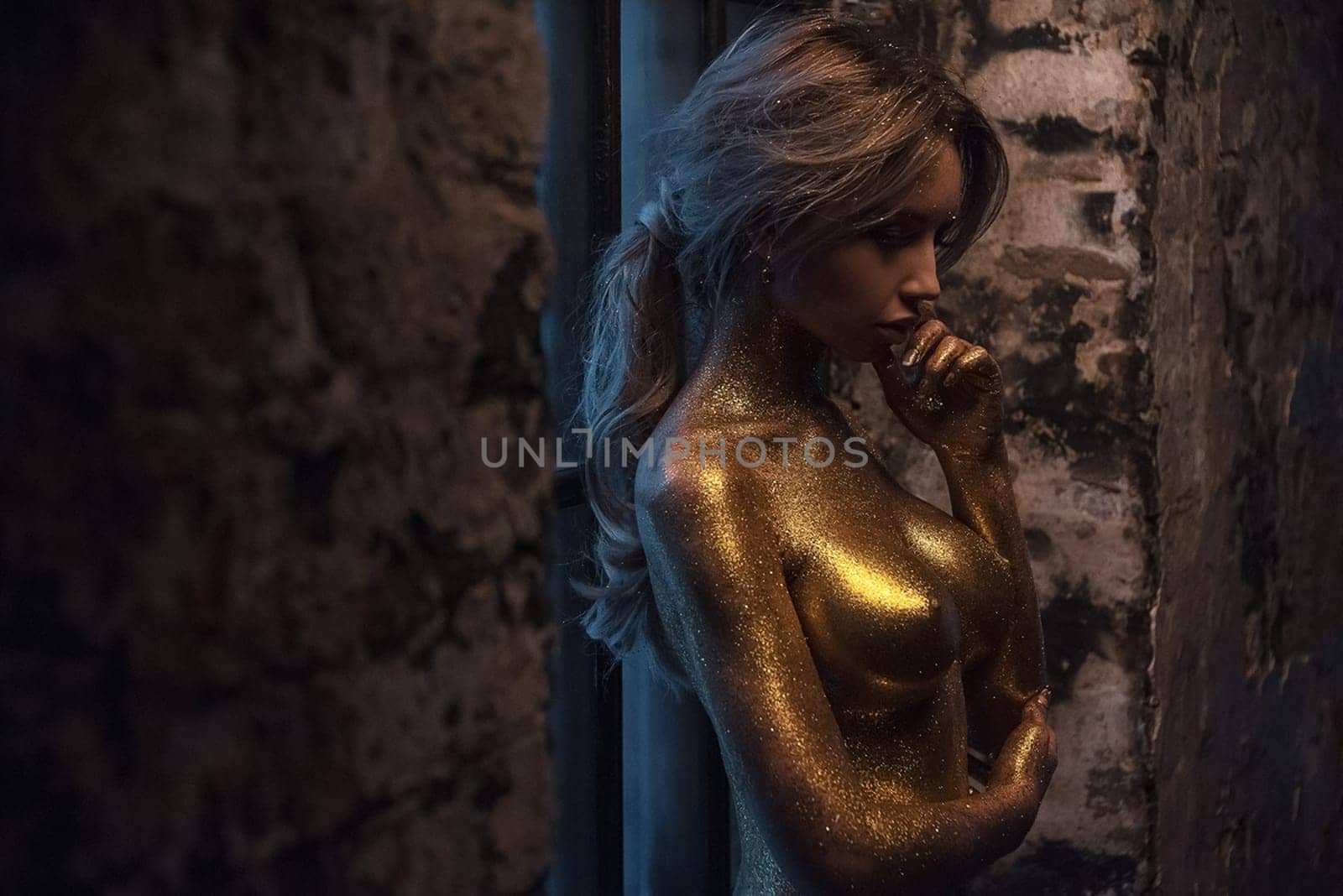 Nude woman in gold paint. Golden body art in gold paint. Golden body art