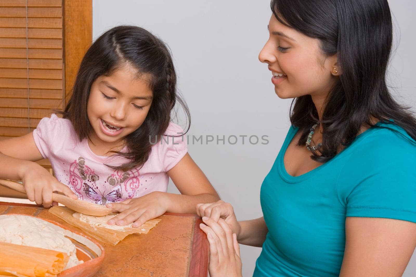 Girl preparing bread with her sister in the kitchen