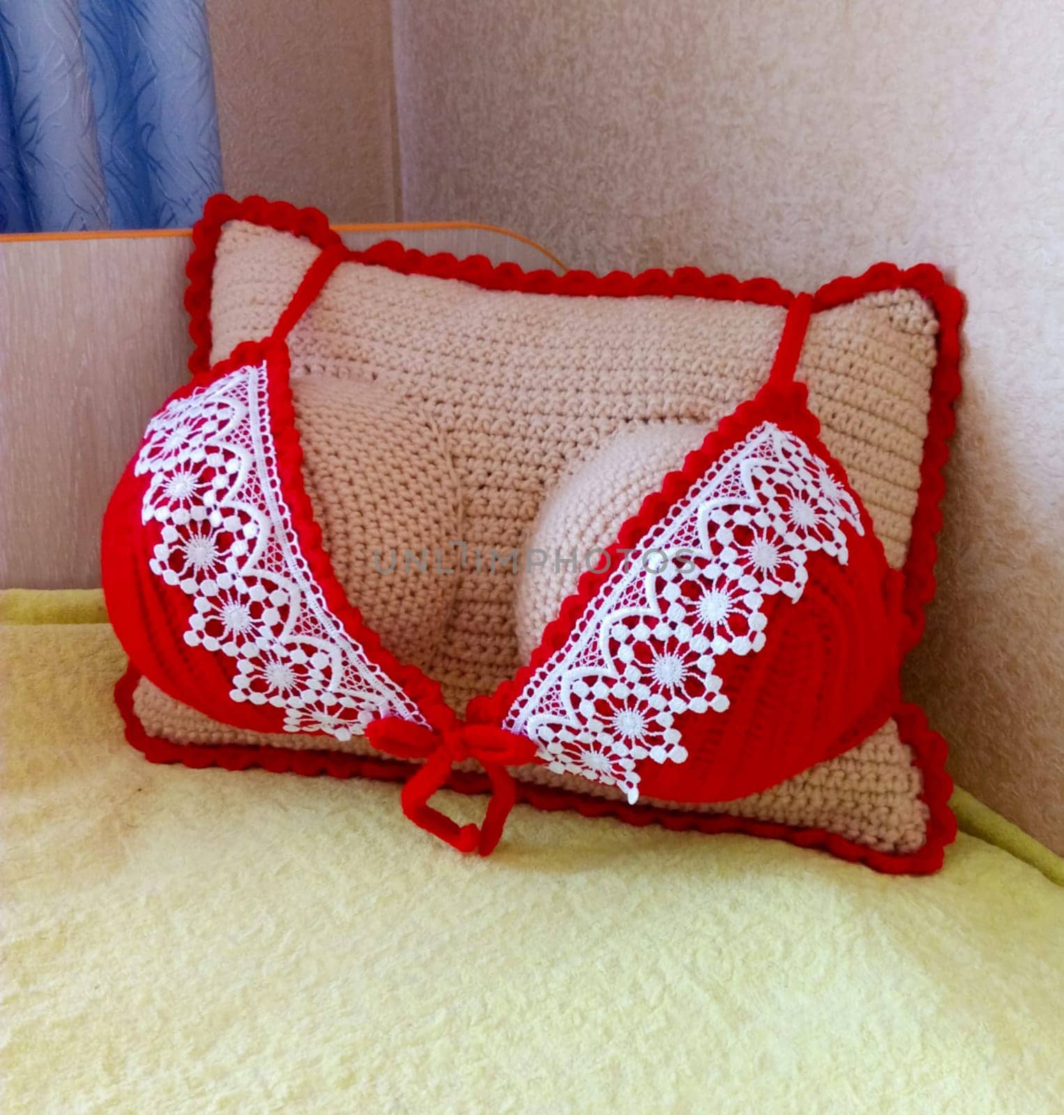 A sofa cushion in the shape of a woman's breast.