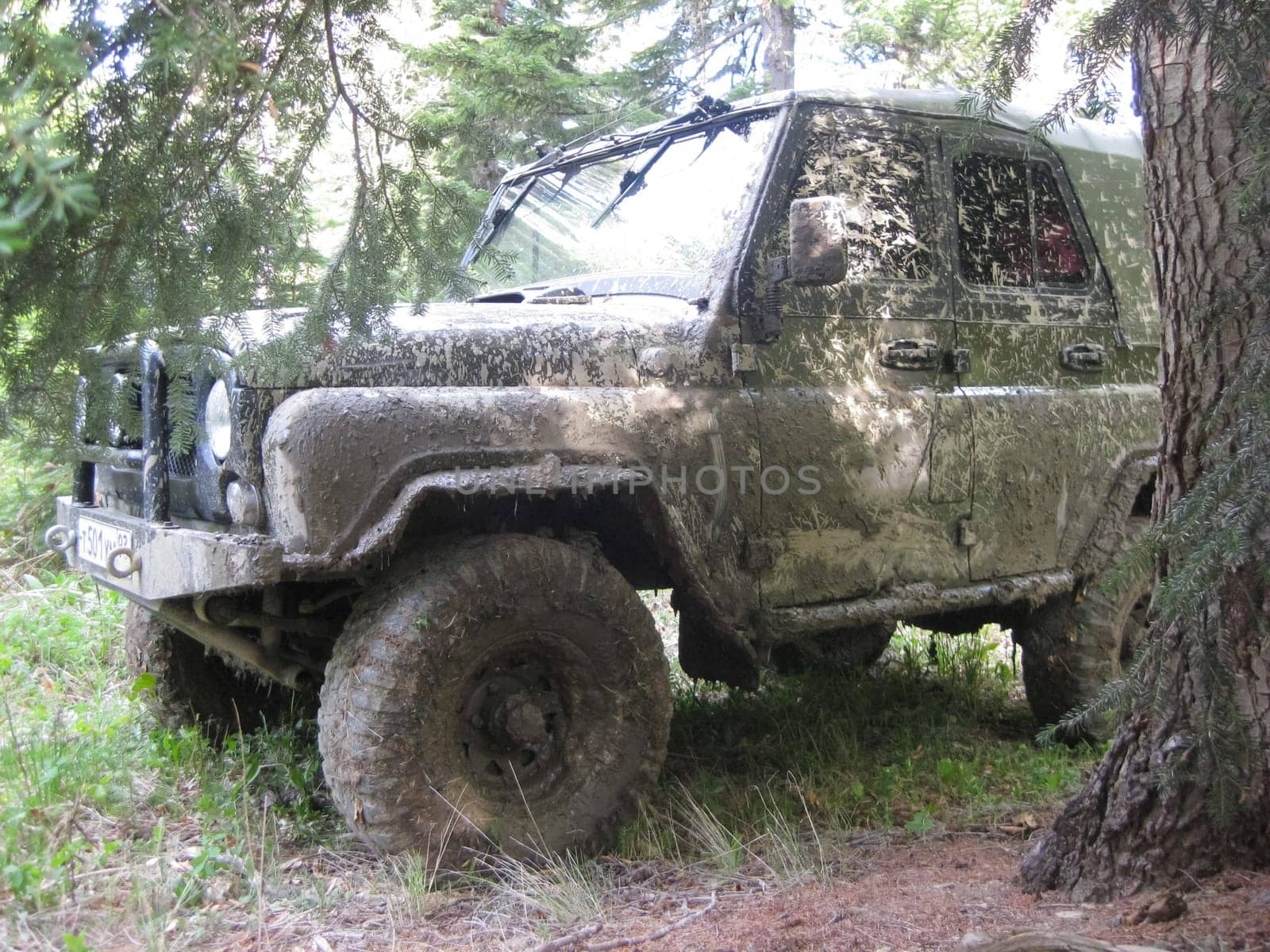 Moscow, Russia - June 23, 2019: It's a very dirty car. The SUV is driving through the mud.