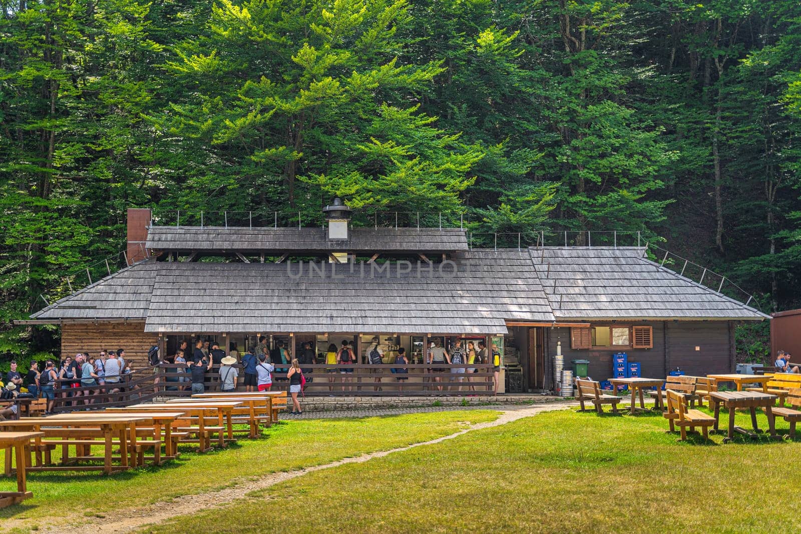 Plitvicka Jezera, Croatia, July 2019 Tourists queueing to buy food in wooden restaurant in Plitvice Lakes National Park UNESCO World Heritage
