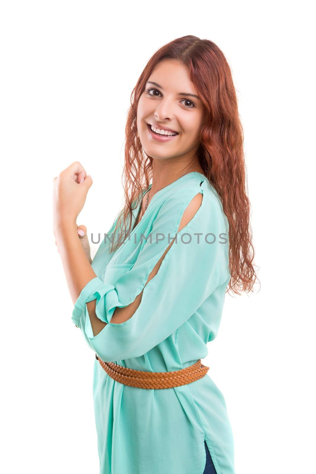 Studio shot: Happy woman with raised arms