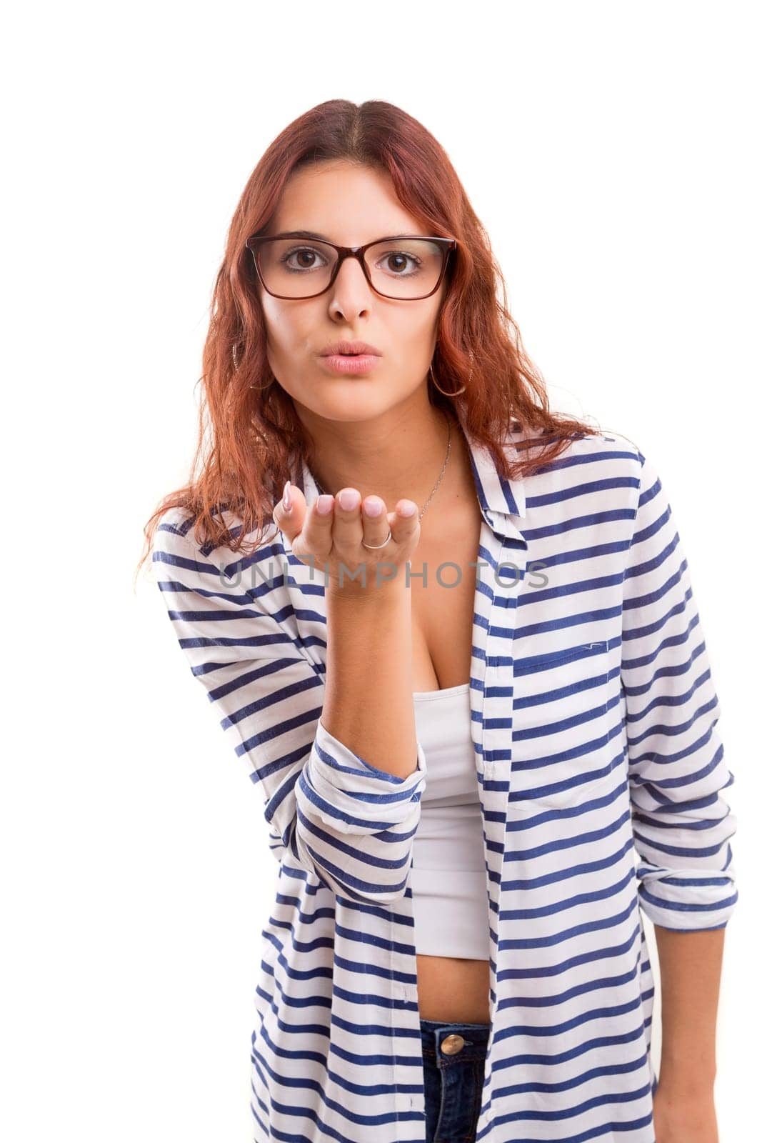 Beautiful young woman blowing you a kiss, isolated over white