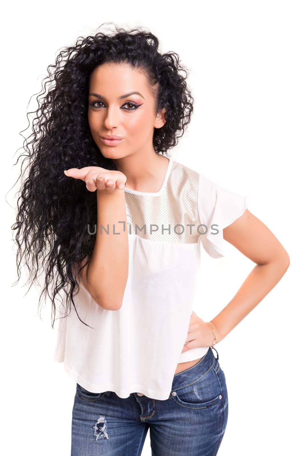 Beautiful young woman blowing you a kiss, isolated over white