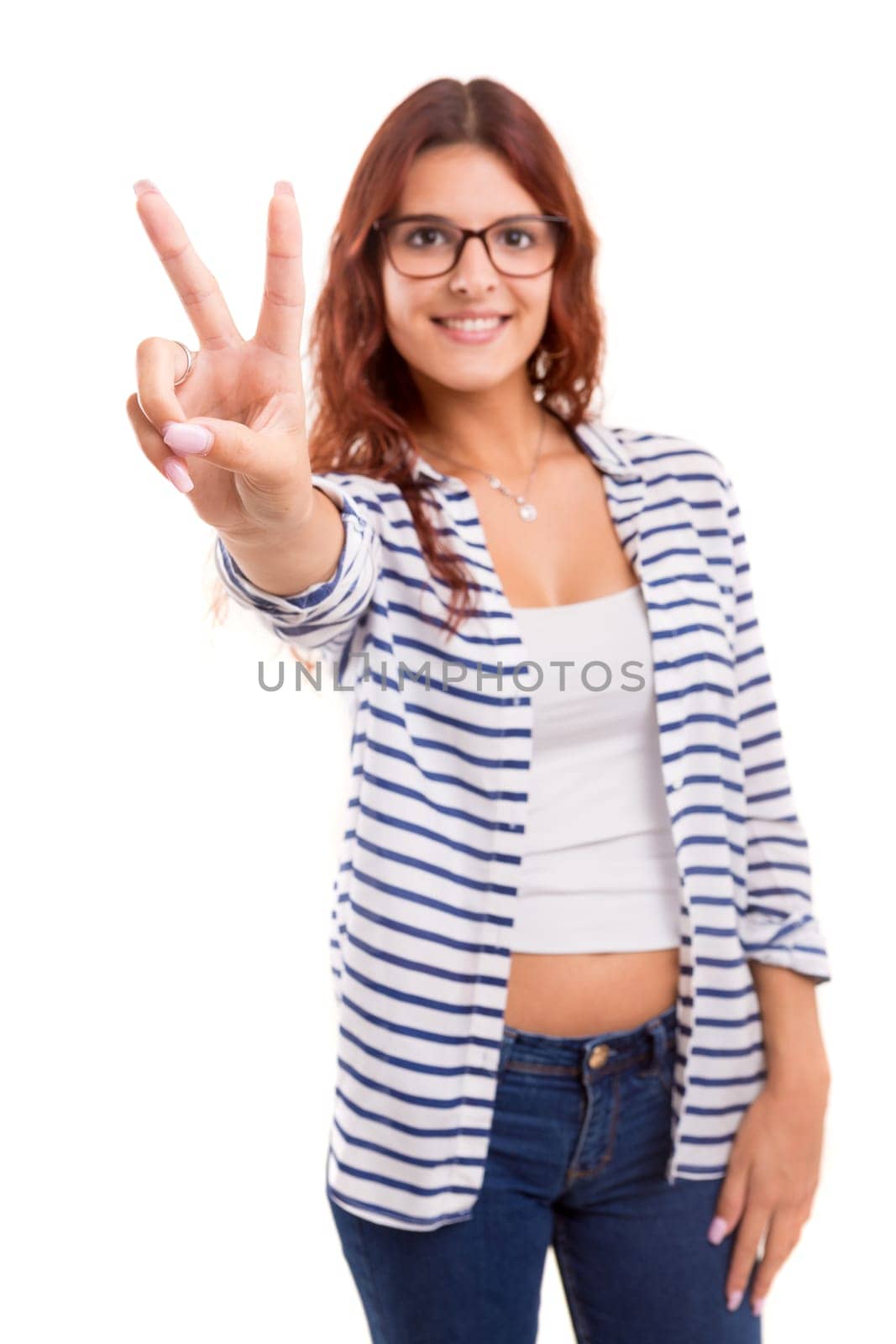 Beautiful young woman signaling ok, isolated over white