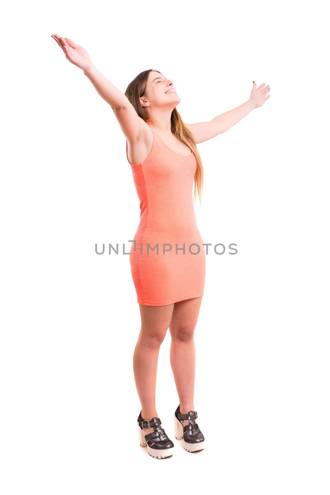 Studio shot: Happy woman with raised arms