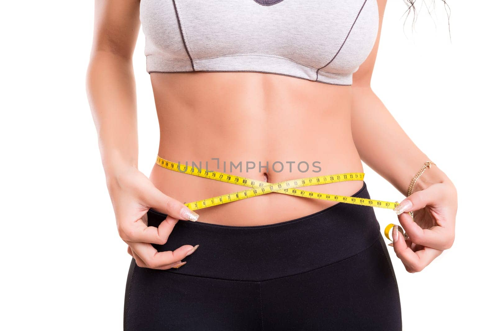 Woman measuring her body - fitness concept