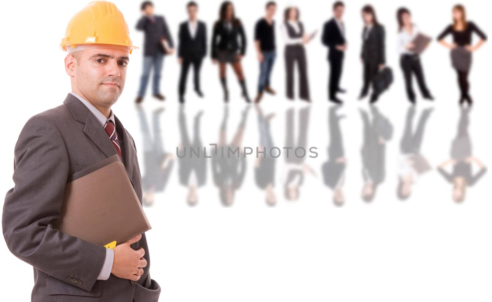 Business man posing with some people in background