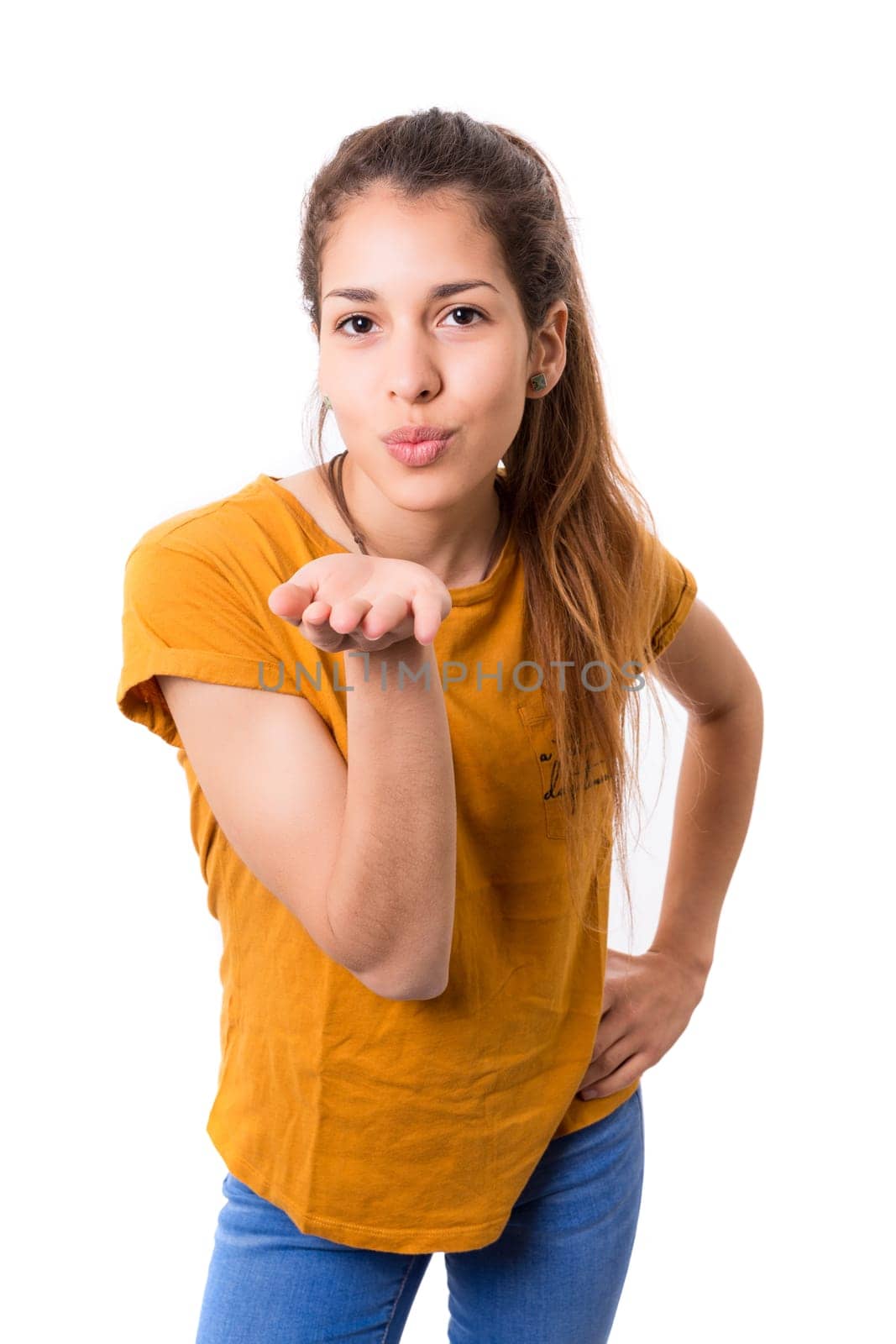 Beautiful young woman blowing you a kiss, isolated over white