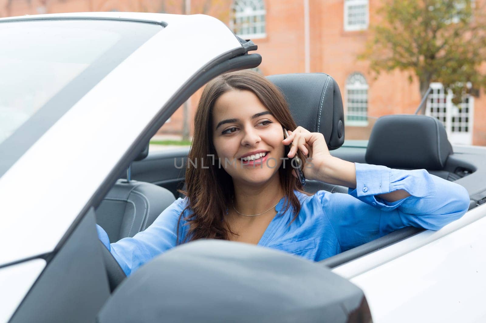 Business woman at the phone while driving