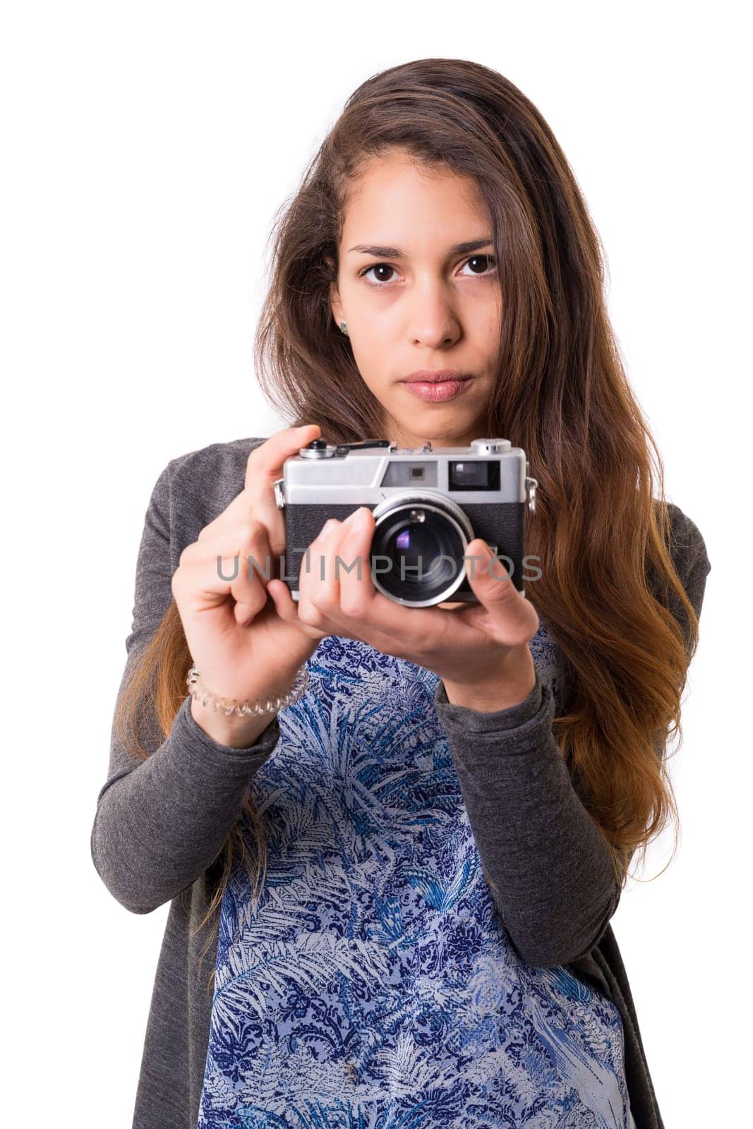 Beautiful woman holding a vintage camera, isolated over white background