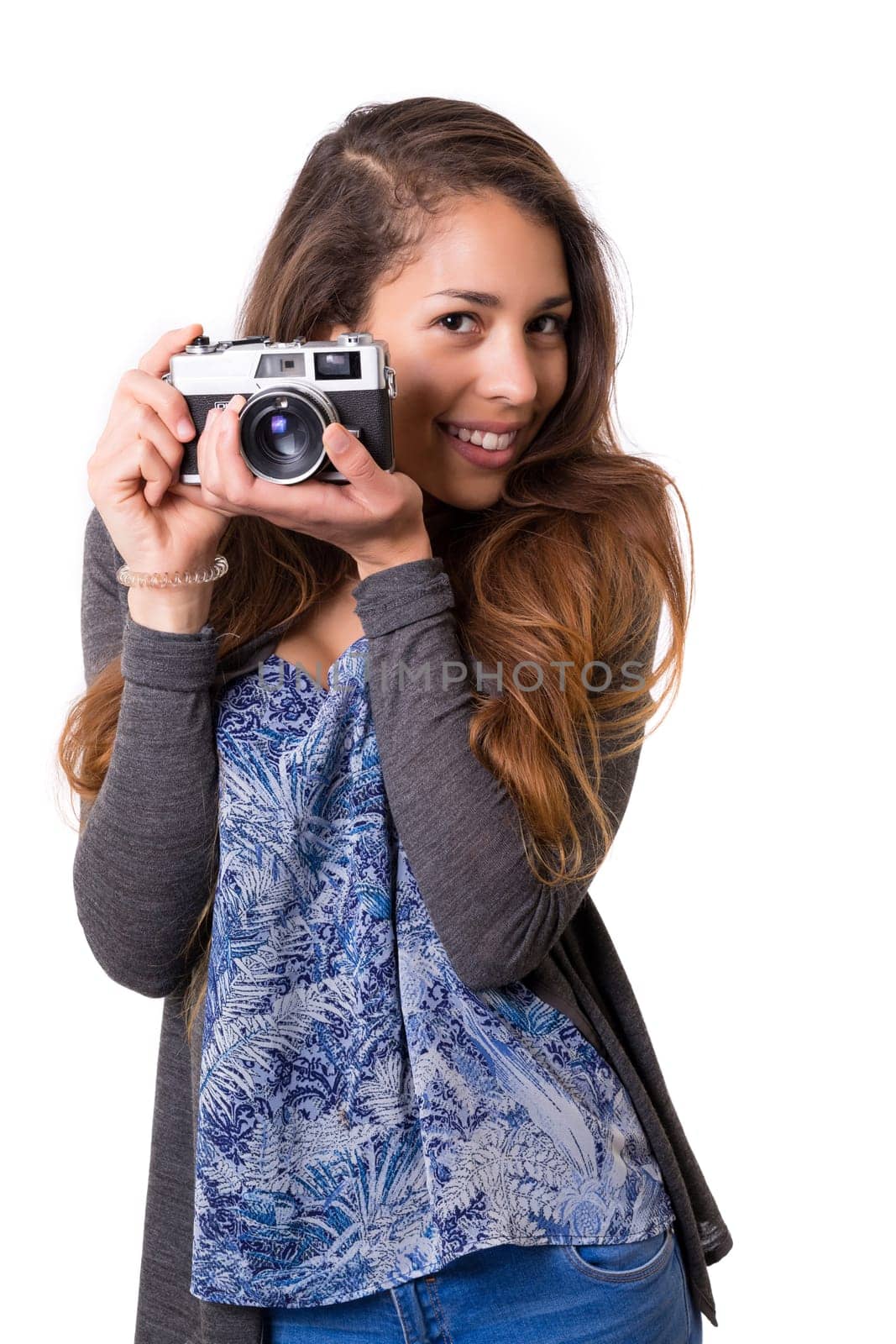 Beautiful woman holding a vintage camera, isolated over white background