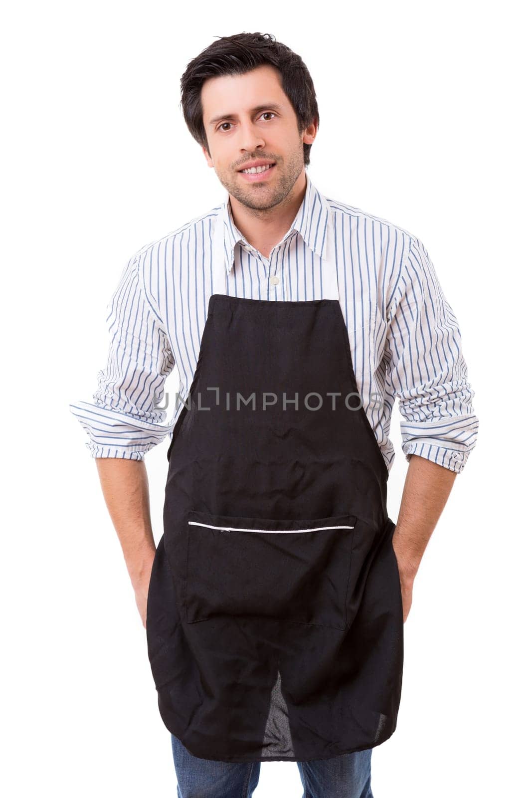 Portrait of handsome young man with apron against white background