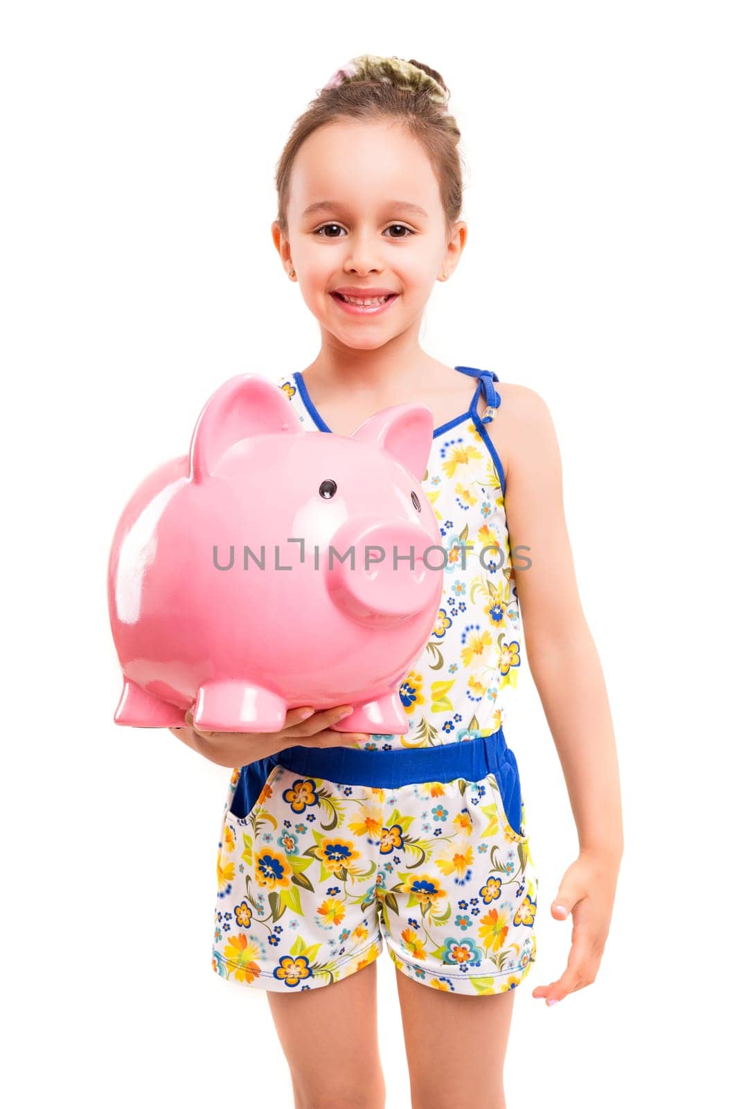 Happy young girl with a new piggy bank to start her savings