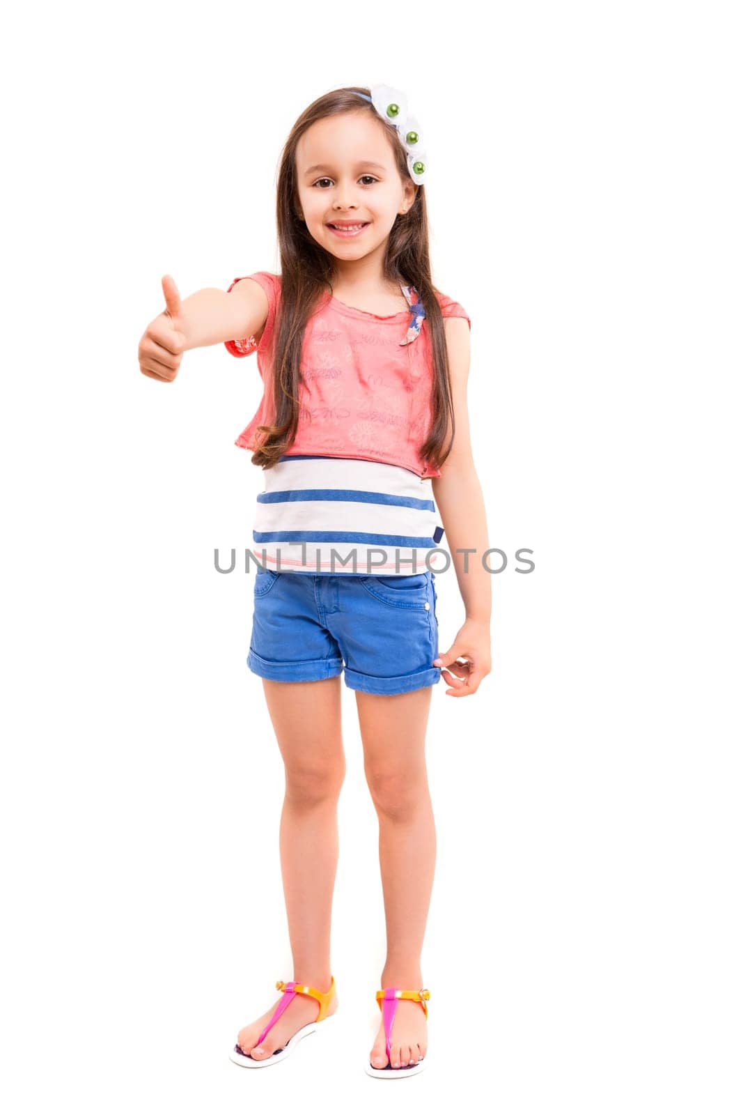 Small girl showing thumbs up, isolated over white background