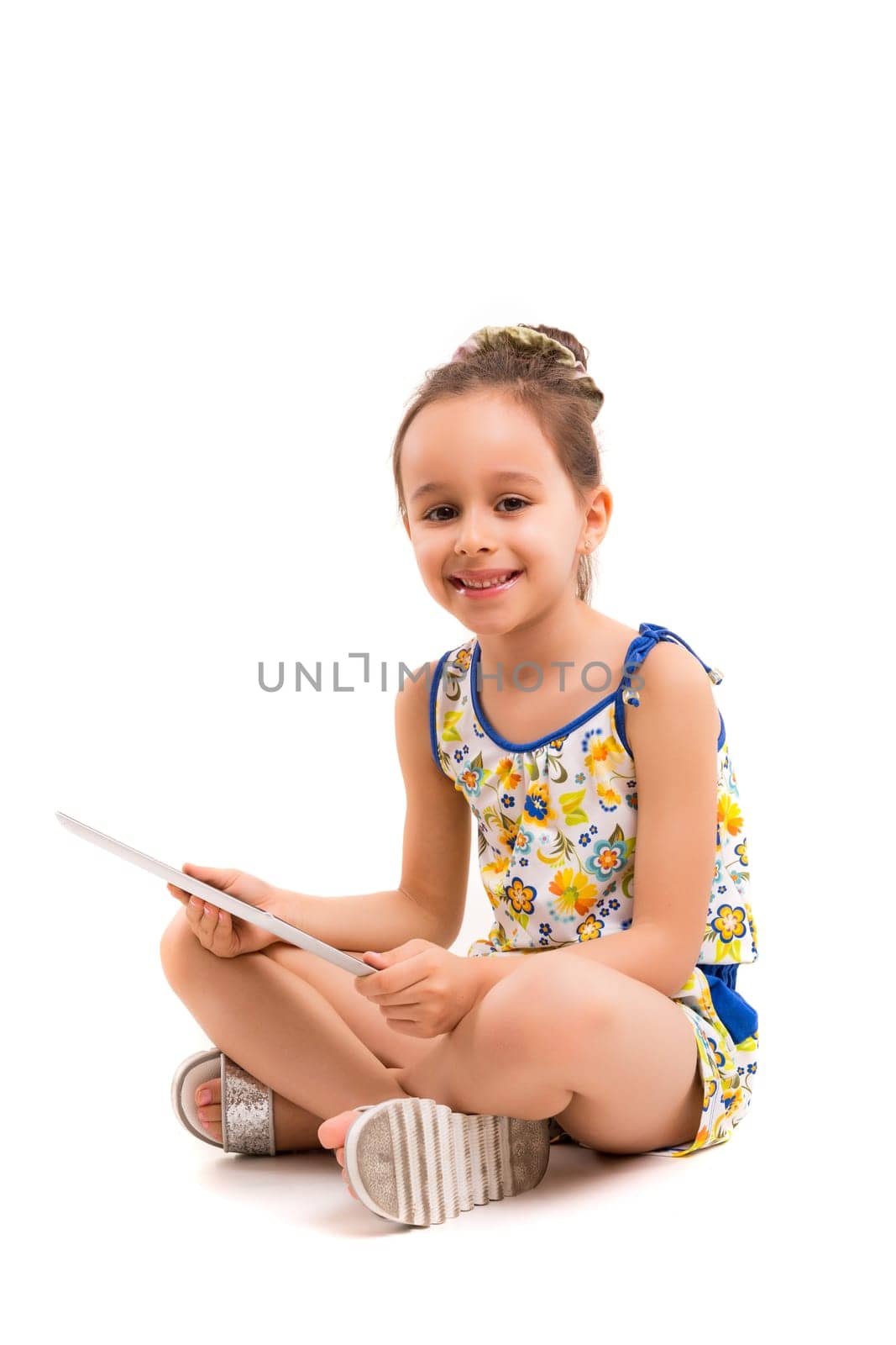 Small girl playing with her new tablet computer
