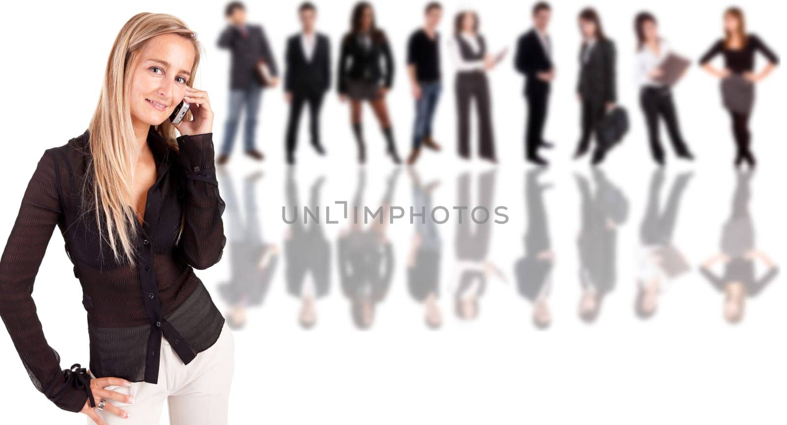 Business woman at the phone with group of people in the back