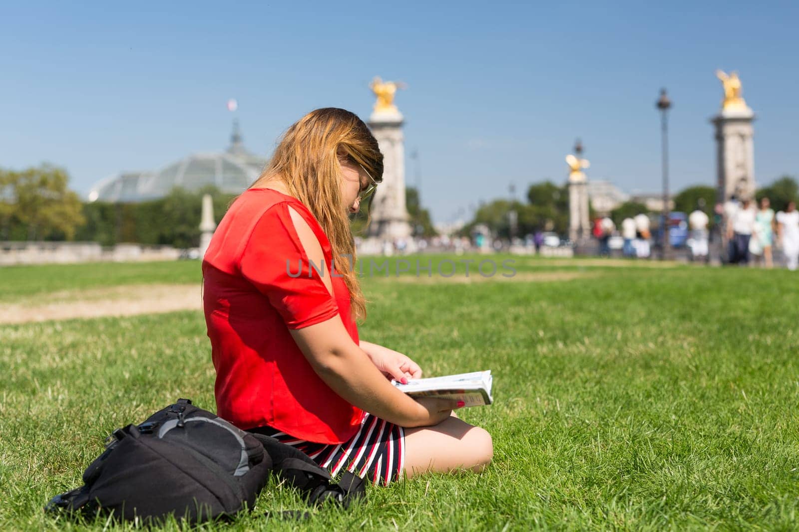 Lucky girl relaxing in the gardens next to the Invalides and the Alexander the 3rd bridge in Paris