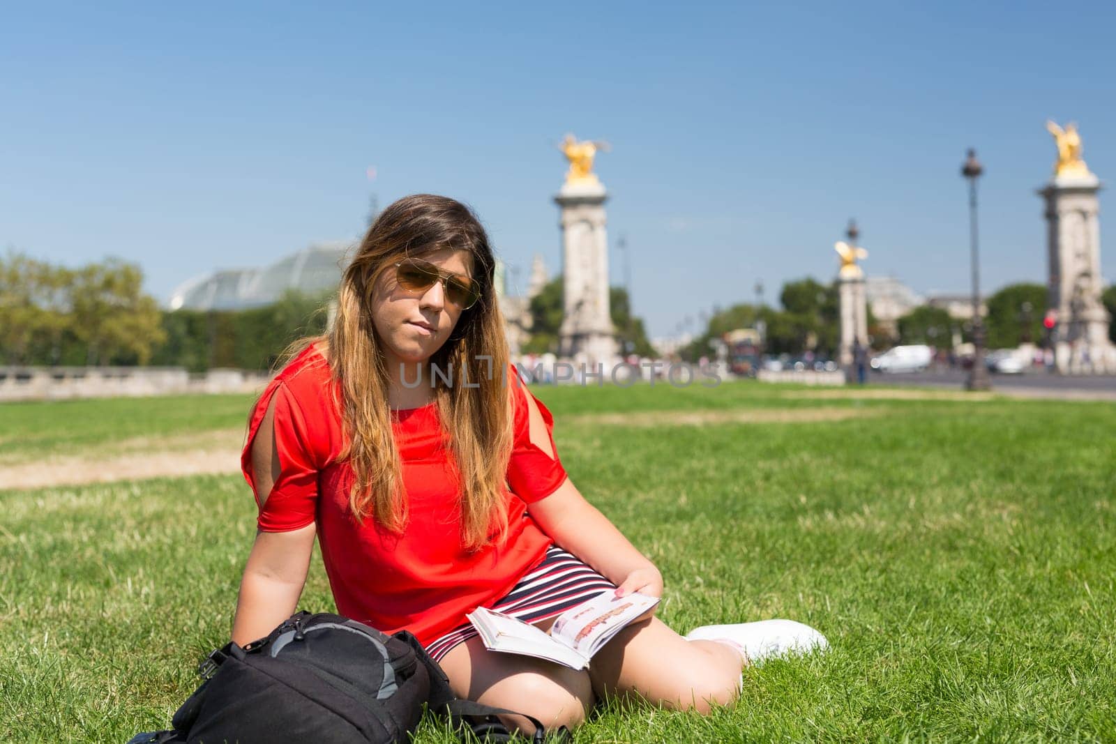 Lucky girl relaxing in the gardens next to the Invalides and the Alexander the 3rd bridge in Paris