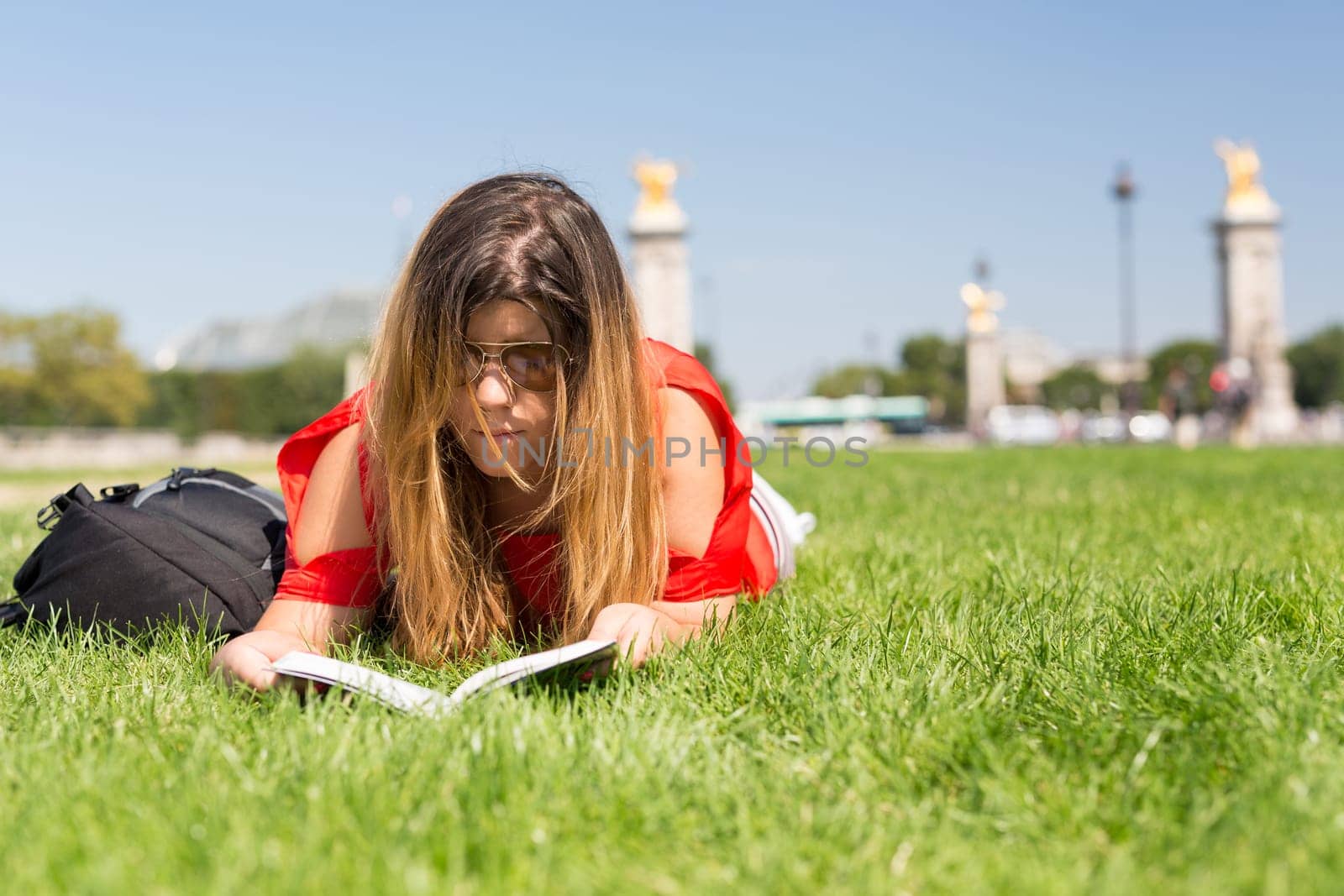 Lucky girl relaxing in the gardens next to the Invalides and the Alexander the 3rd bridge in Paris
