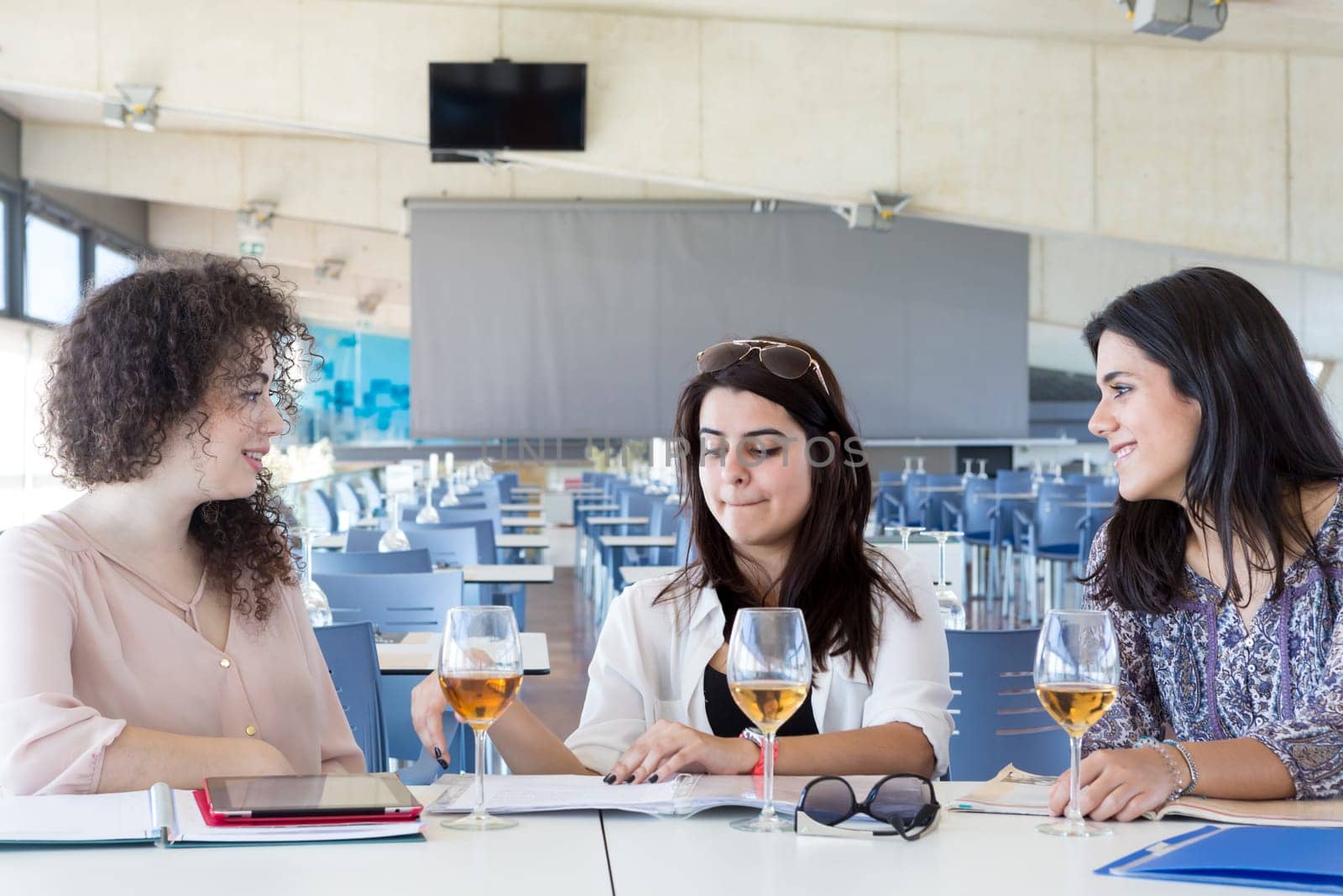 Group of happy students preparing their exams or simply relaxing at a bar