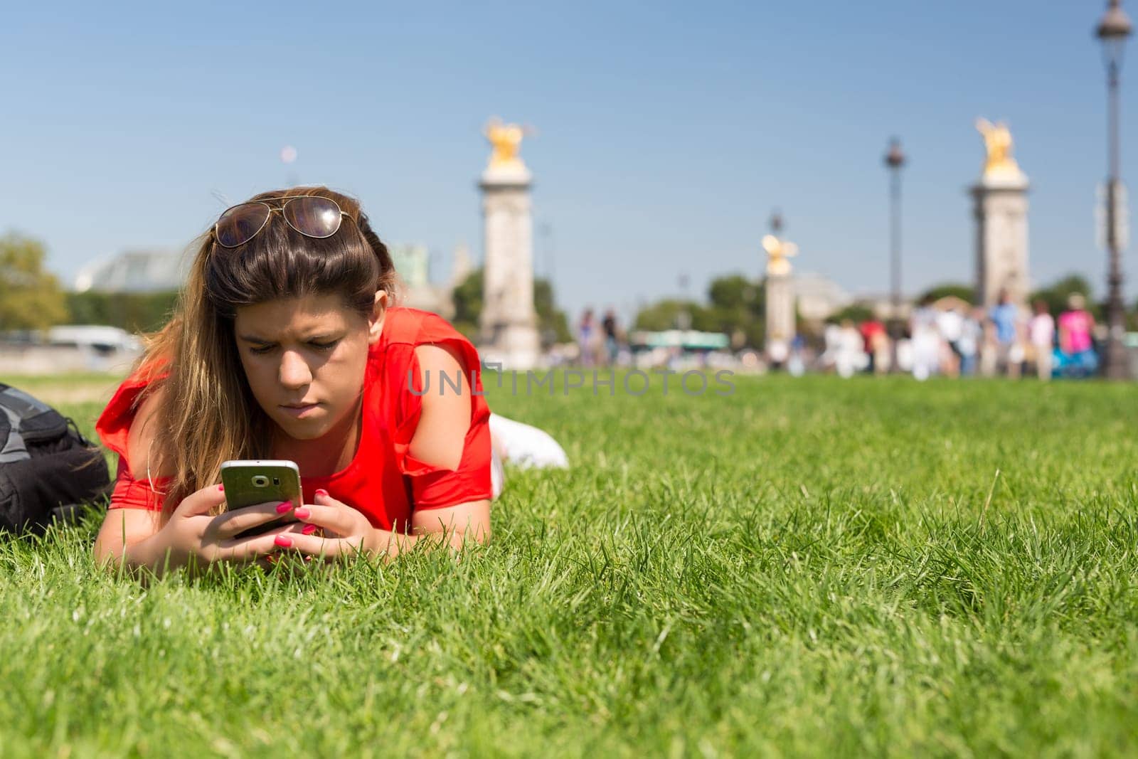 Lucky woman in Paris checking her smartphone for news