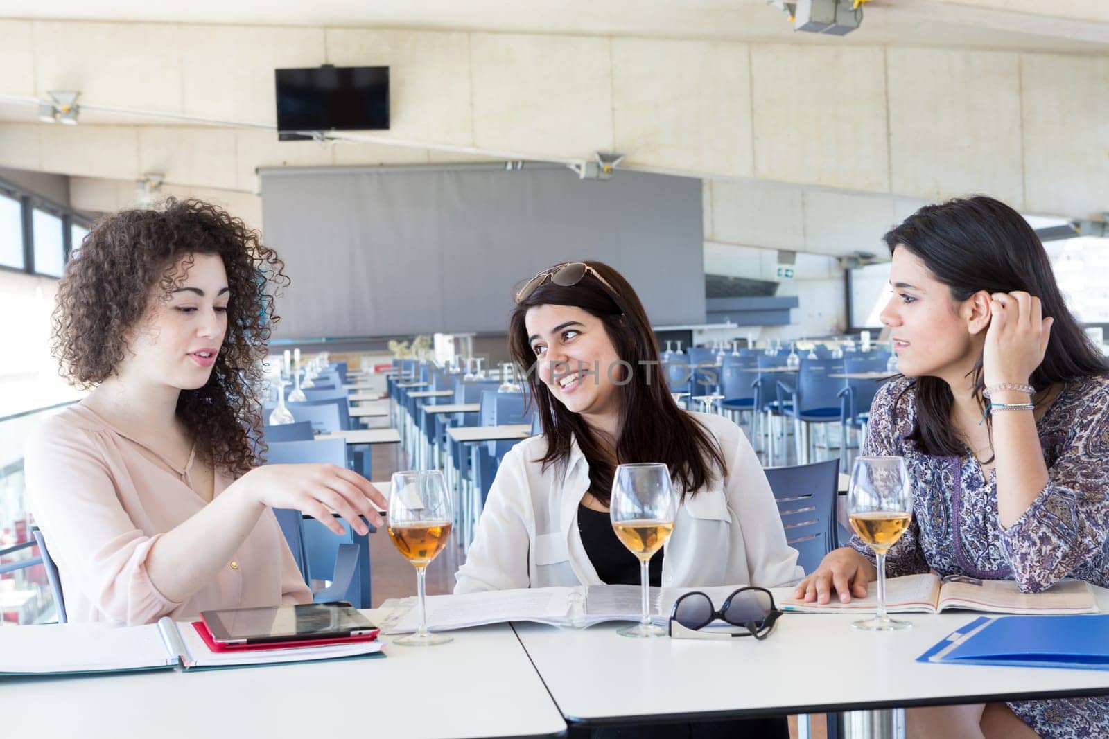 Group of happy students preparing their exams or simply relaxing at a bar
