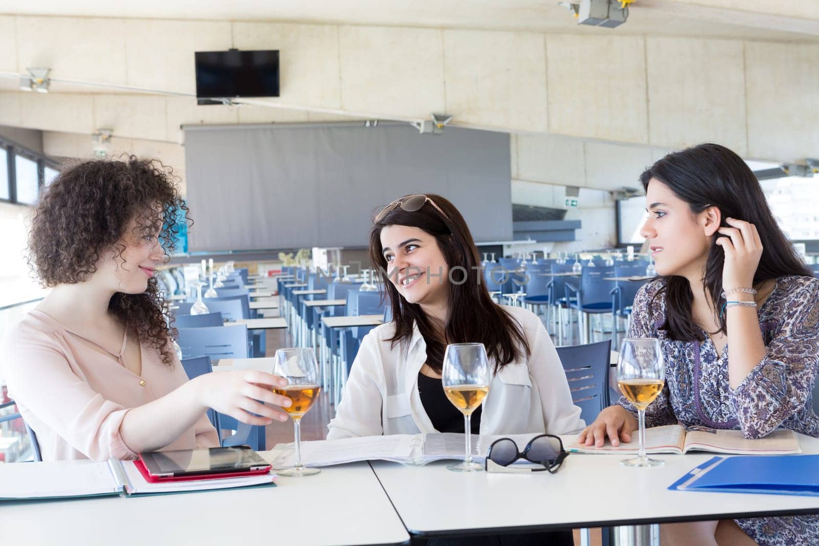 Group of happy students preparing their exams or simply relaxing at a bar