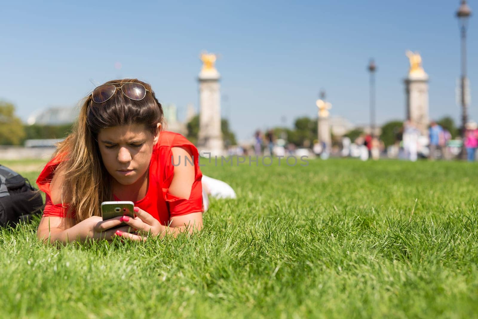 Lucky woman in Paris checking her smartphone for news
