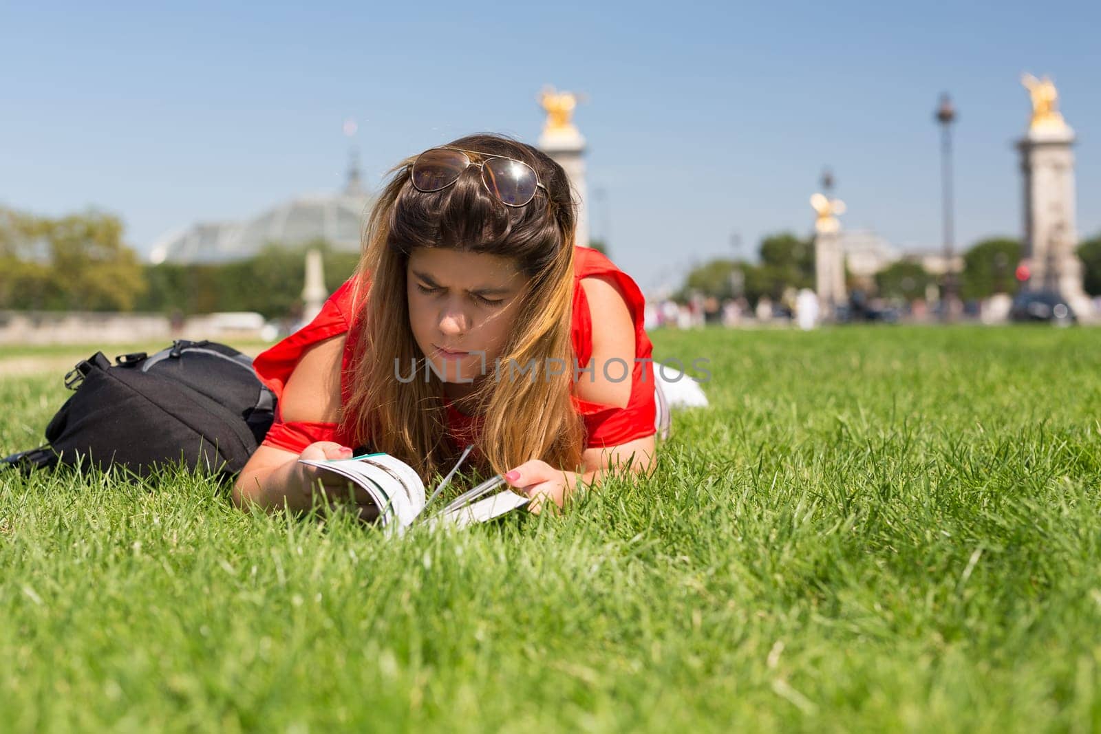 Lucky girl relaxing in the gardens next to the Invalides and the Alexander the 3rd bridge in Paris