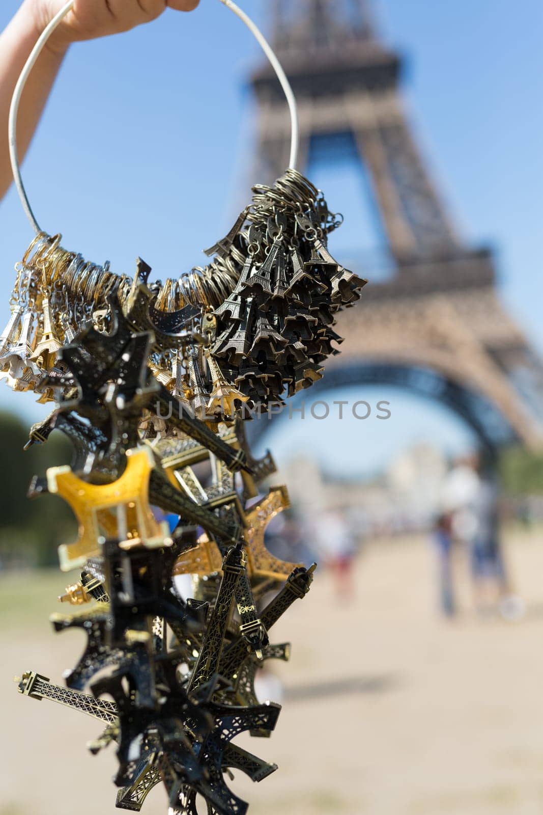 Woman selling small Eiffel Towers in the gardens of the Eiffel Tower, the main attraction in Paris, France