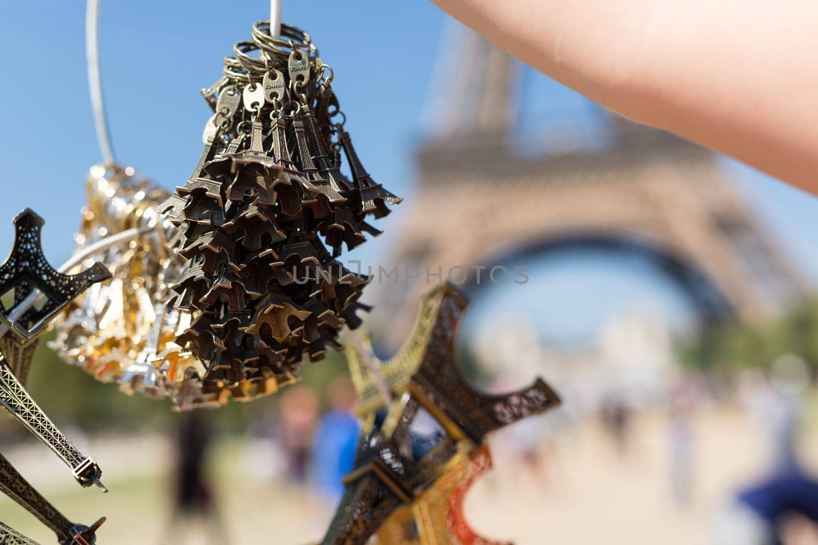 Woman selling small Eiffel Towers in the gardens of the Eiffel Tower, the main attraction in Paris, France