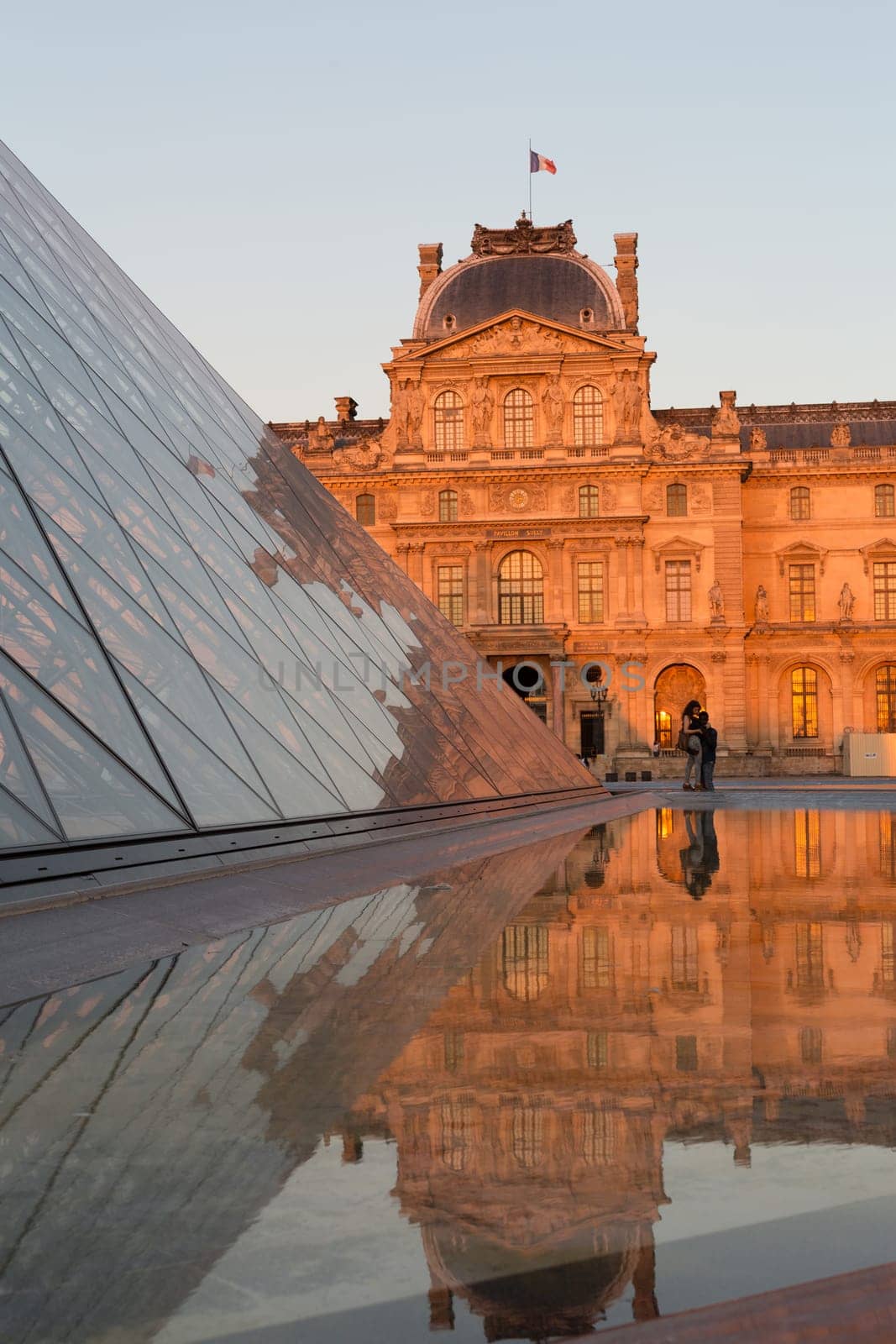 PARIS - AUGUST 15, 2016 Louvre museum at twilight in summer. Louvre Museum is one of the world's largest museums, every year museum visits are more than 8 million visitors.