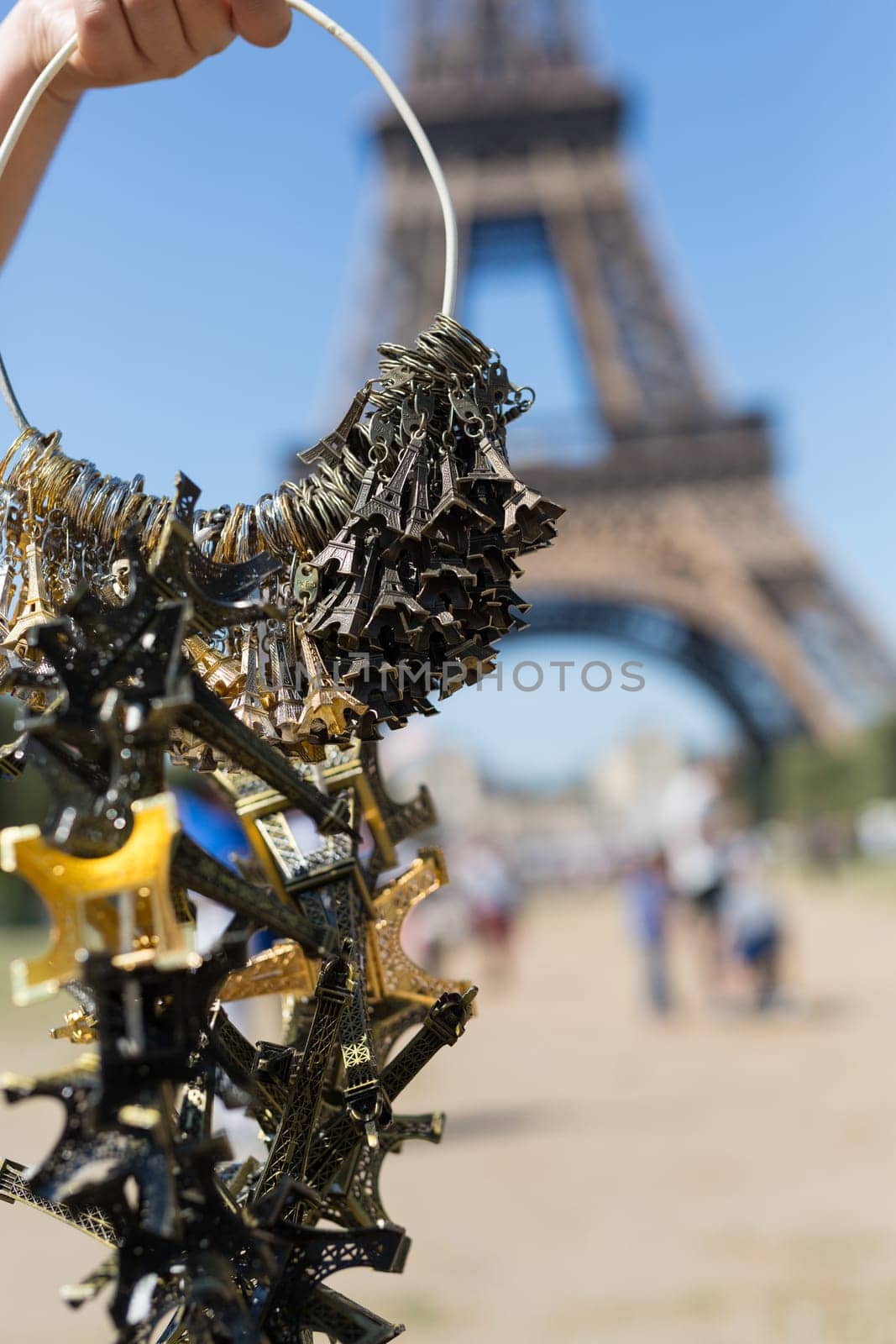 Woman selling small Eiffel Towers in the gardens of the Eiffel Tower, the main attraction in Paris, France