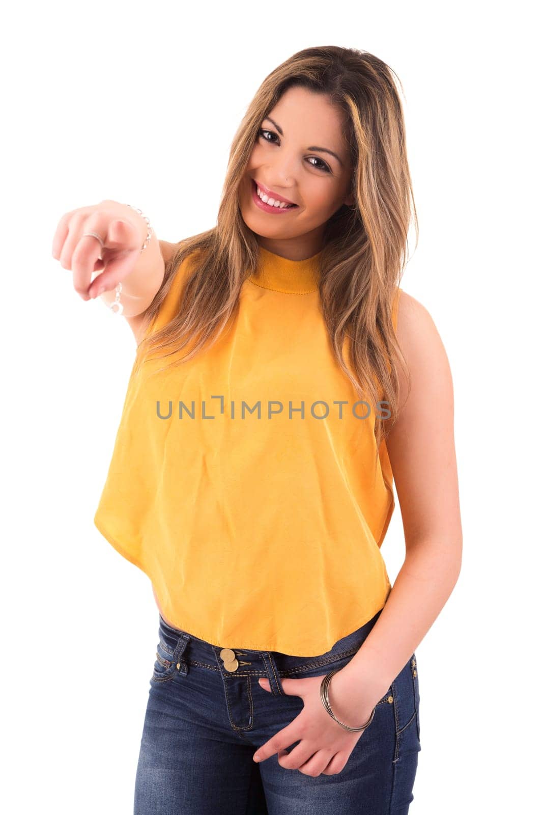 Young beautiful woman pointing at you, isolated over white