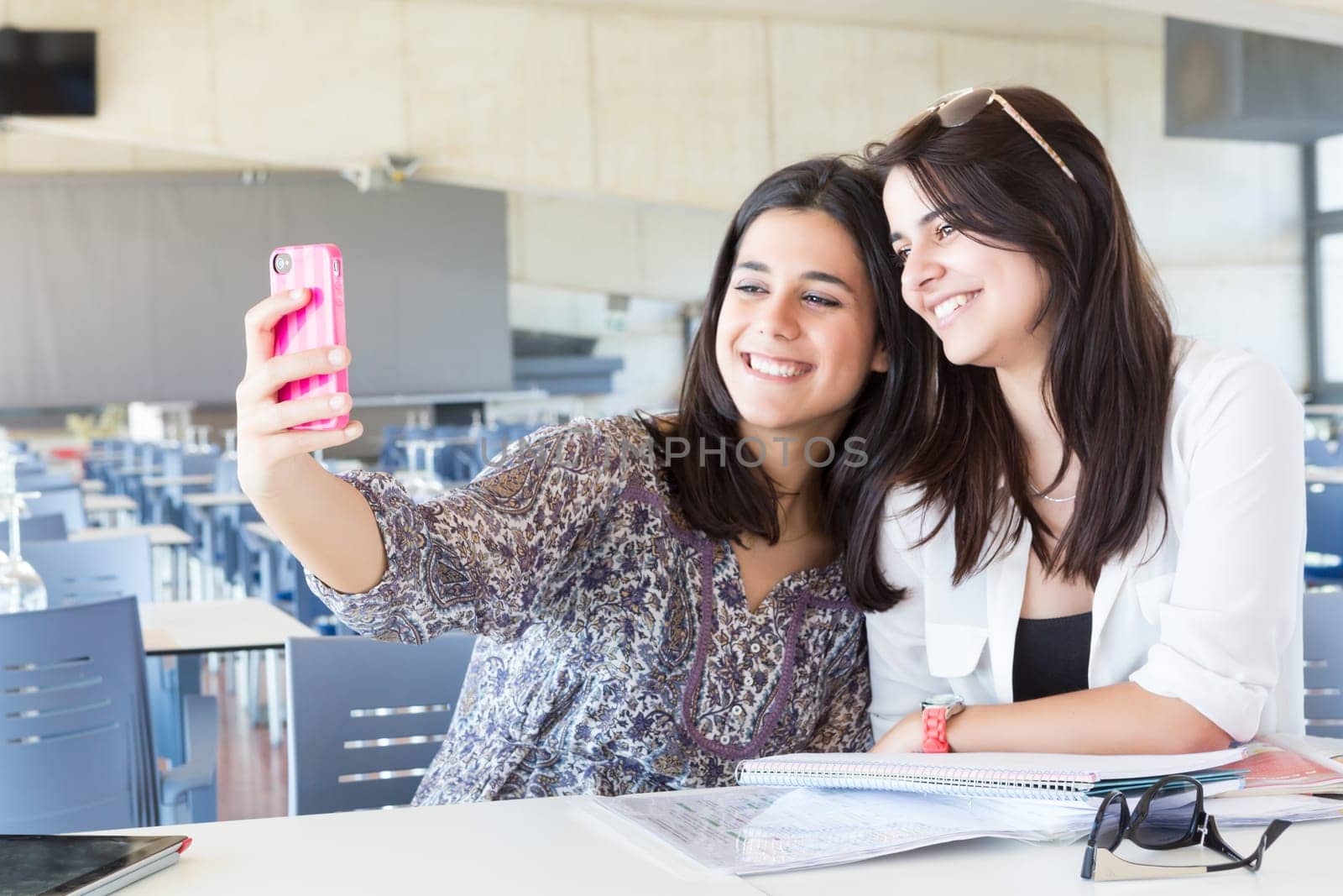 Group of happy students preparing their exams or simply relaxing at a bar