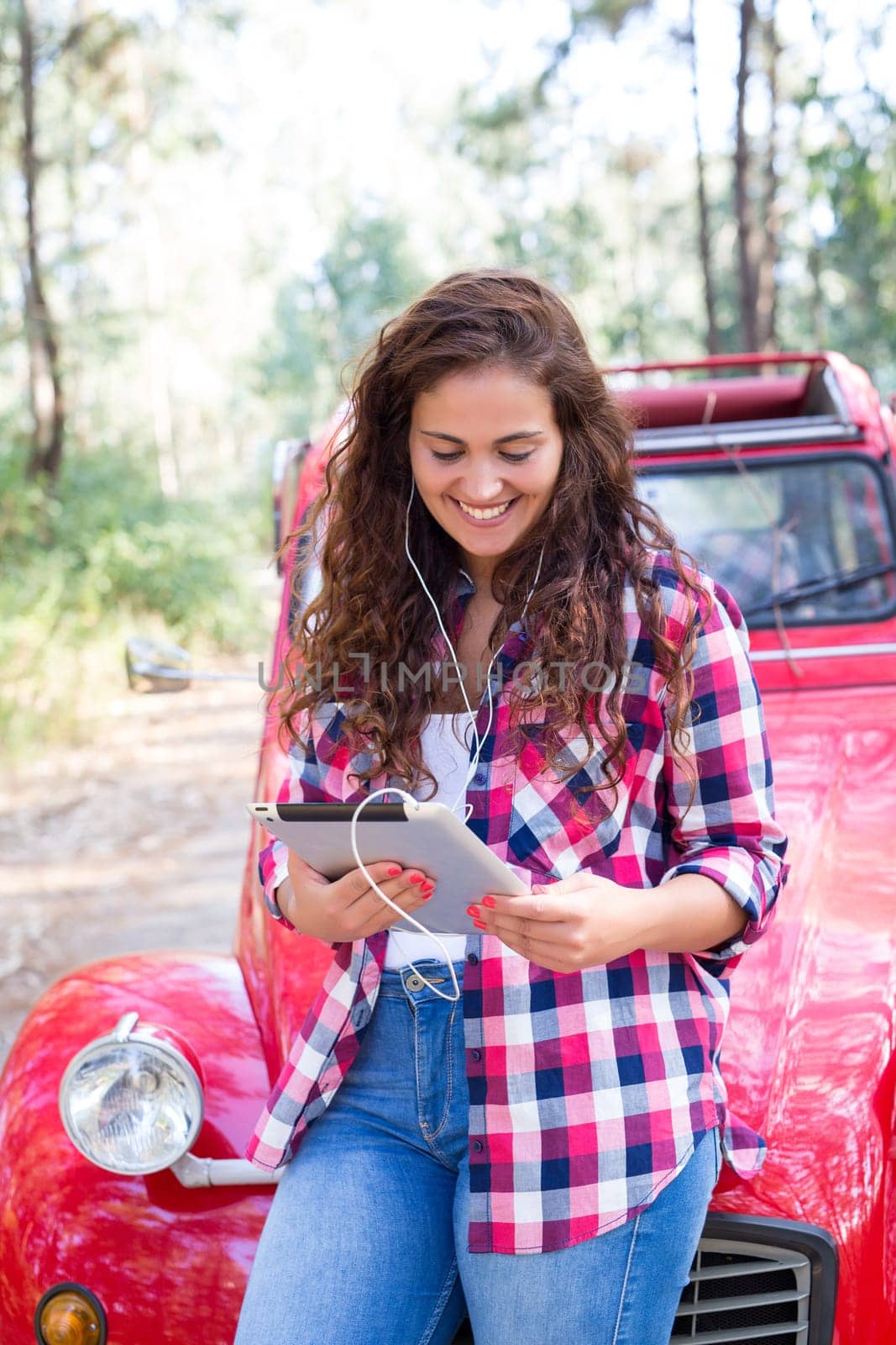 Young woman resting at car trip by the countryside