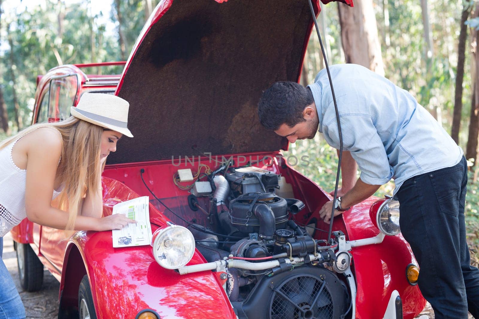 Friends on a roadtrip having a problem with their old car